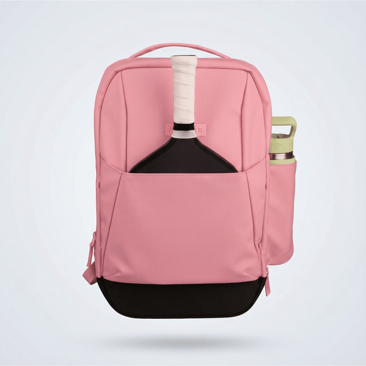 Pink and black pickleball backpack by FORWRD, front view, holding a black paddle in its front pocket and a light green water bottle in its side pocket.