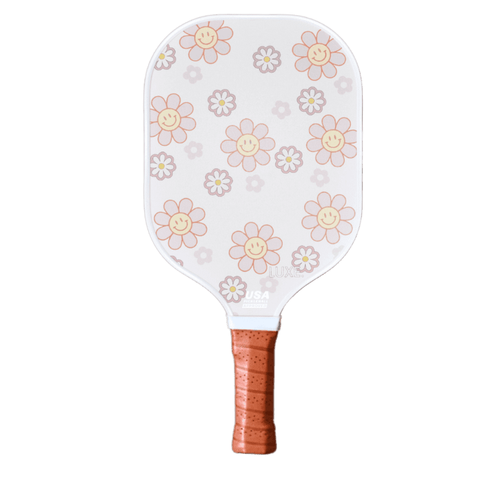 White pickleball paddle with a daisy pattern and brown grip.
