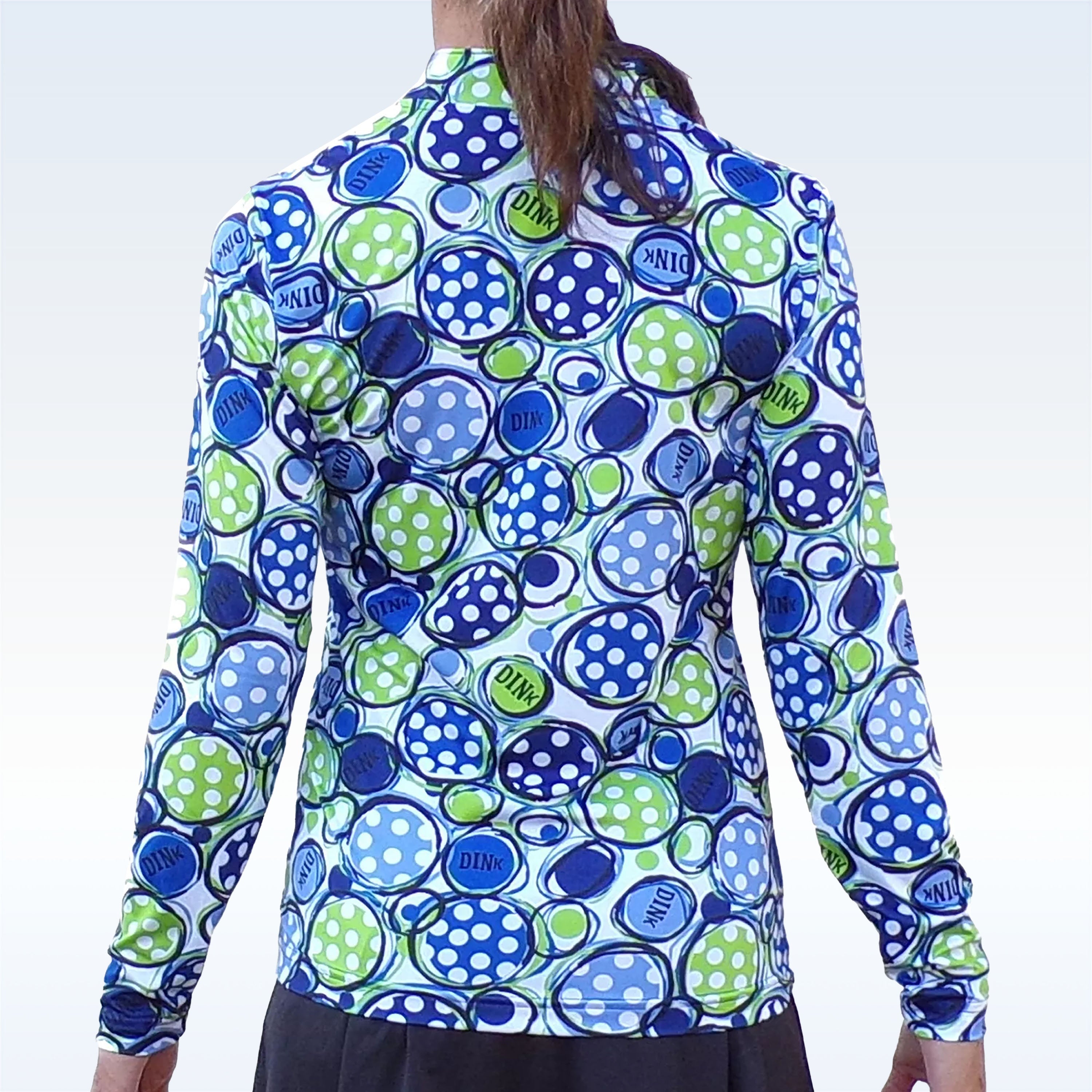 Multi-color long sleeve 1/4 zip top by Pickleball Bella, with blue and green polka dots and 'DINK' text, shown from the back.