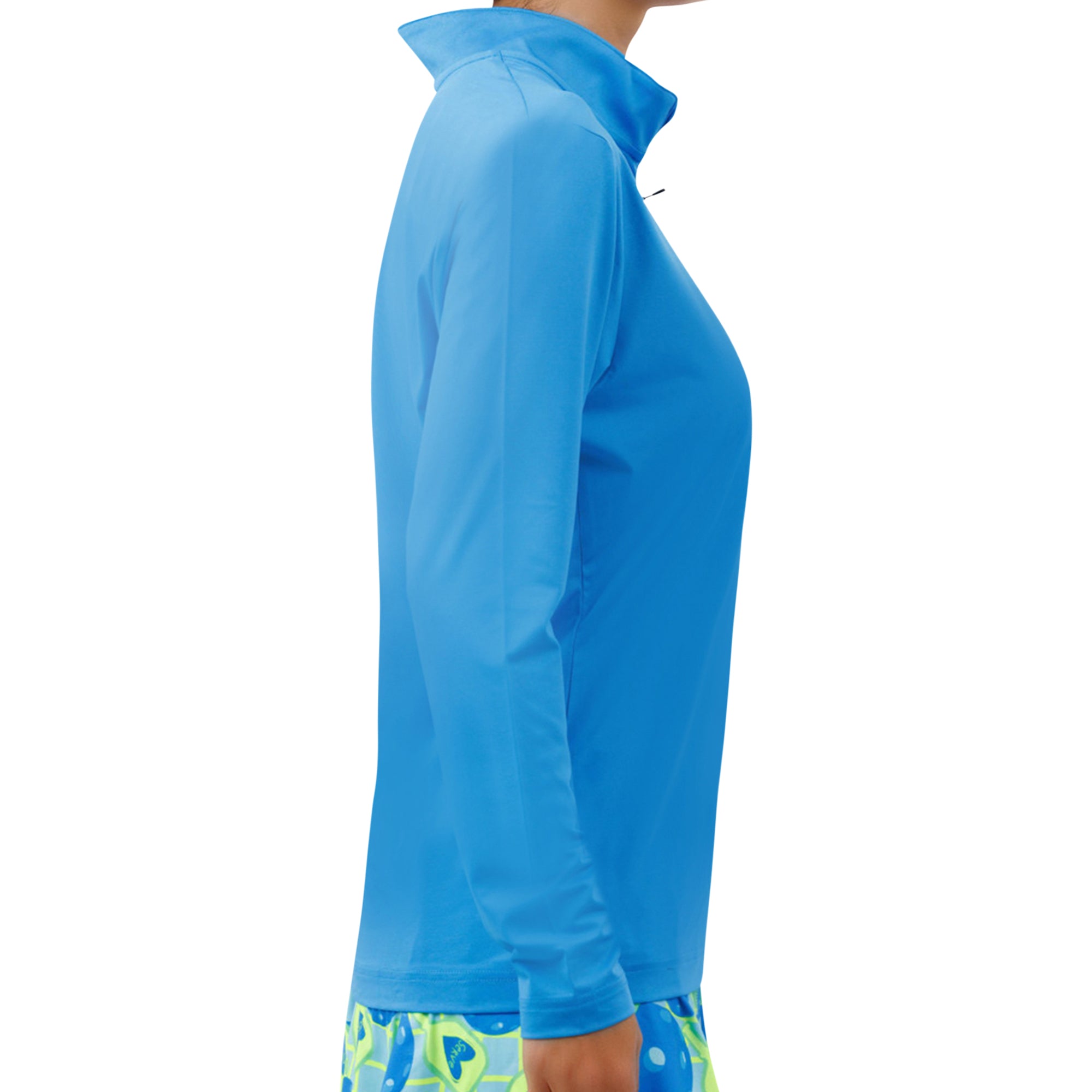 Electric Blue 1/4 Zip Long Sleeve Pullover by Pickleball Bella with a high collar and zipper, worn over a patterned skirt, side view.