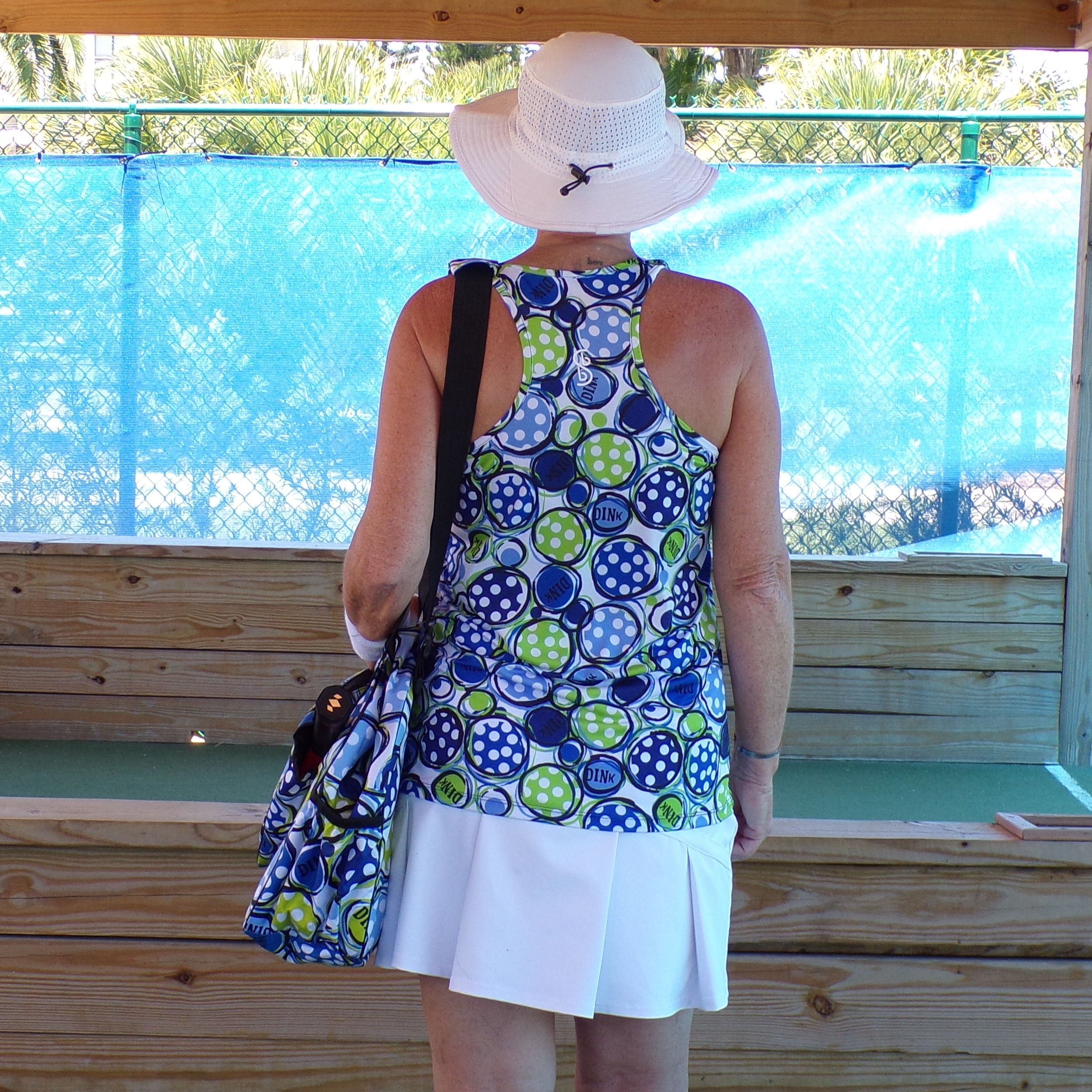 Blue and green polka dot racerback tank by Pickleball Bella with 'DINK' text and logo, shown from back with matching bag.