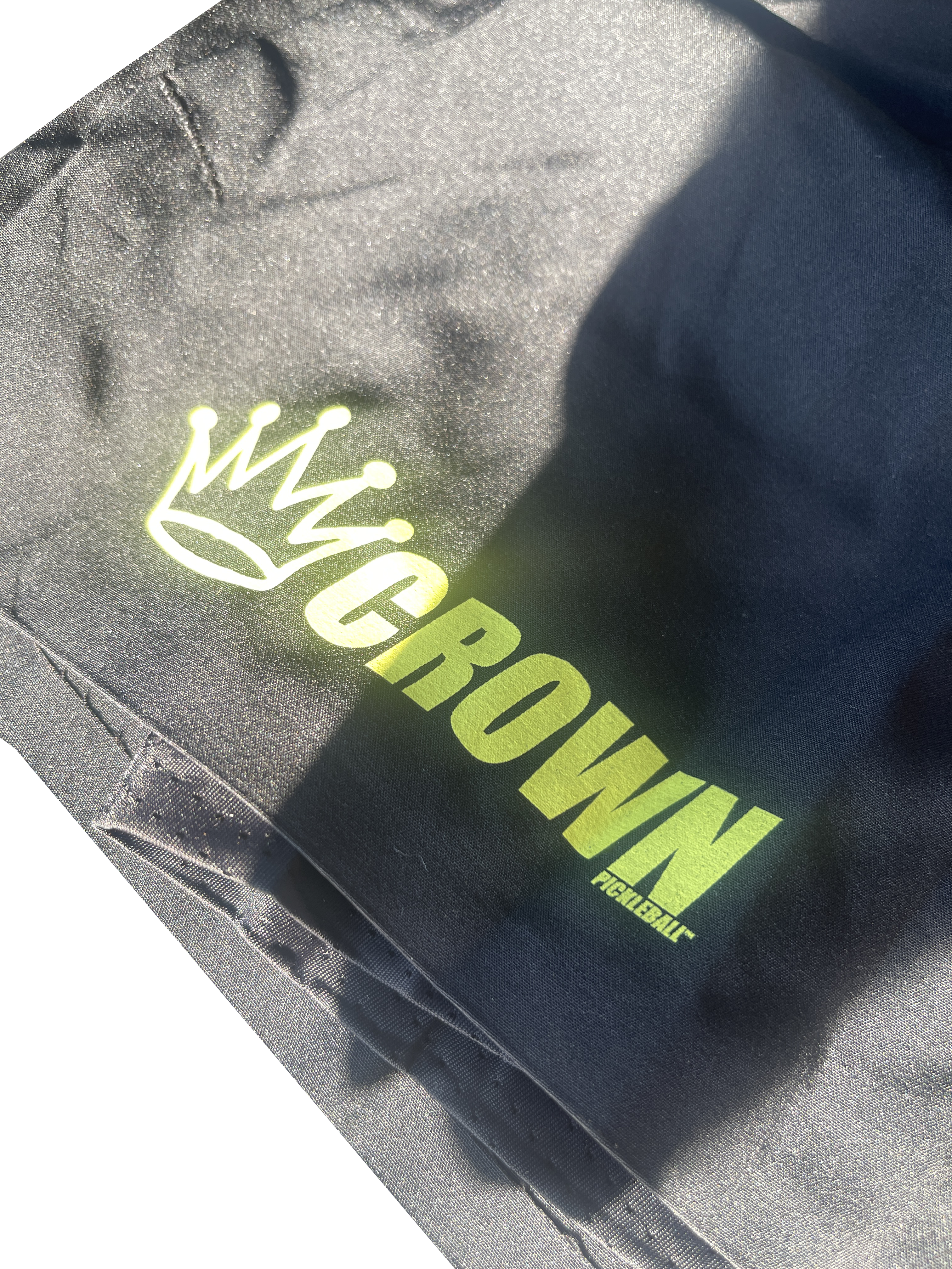 Black fabric bag with a yellow "Crown Pickleball" logo.