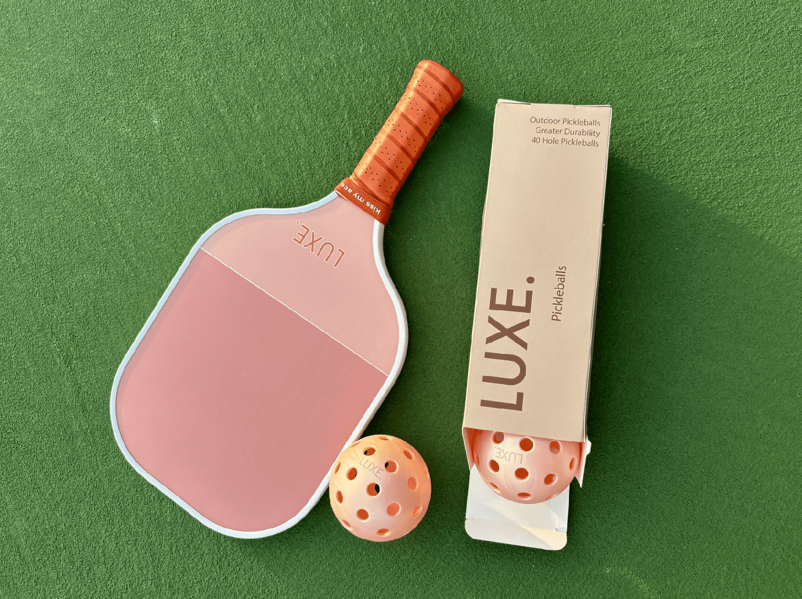 Pickleball set with paddle, ball, and packaging.