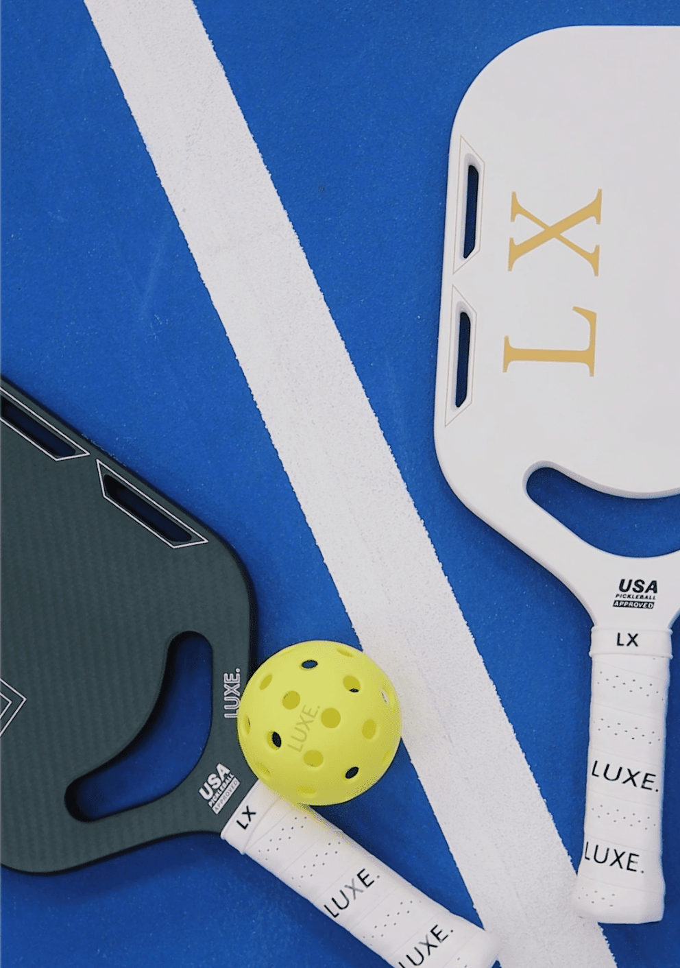 Two pickleball paddles, a yellow pickleball, and white lines on a blue court.