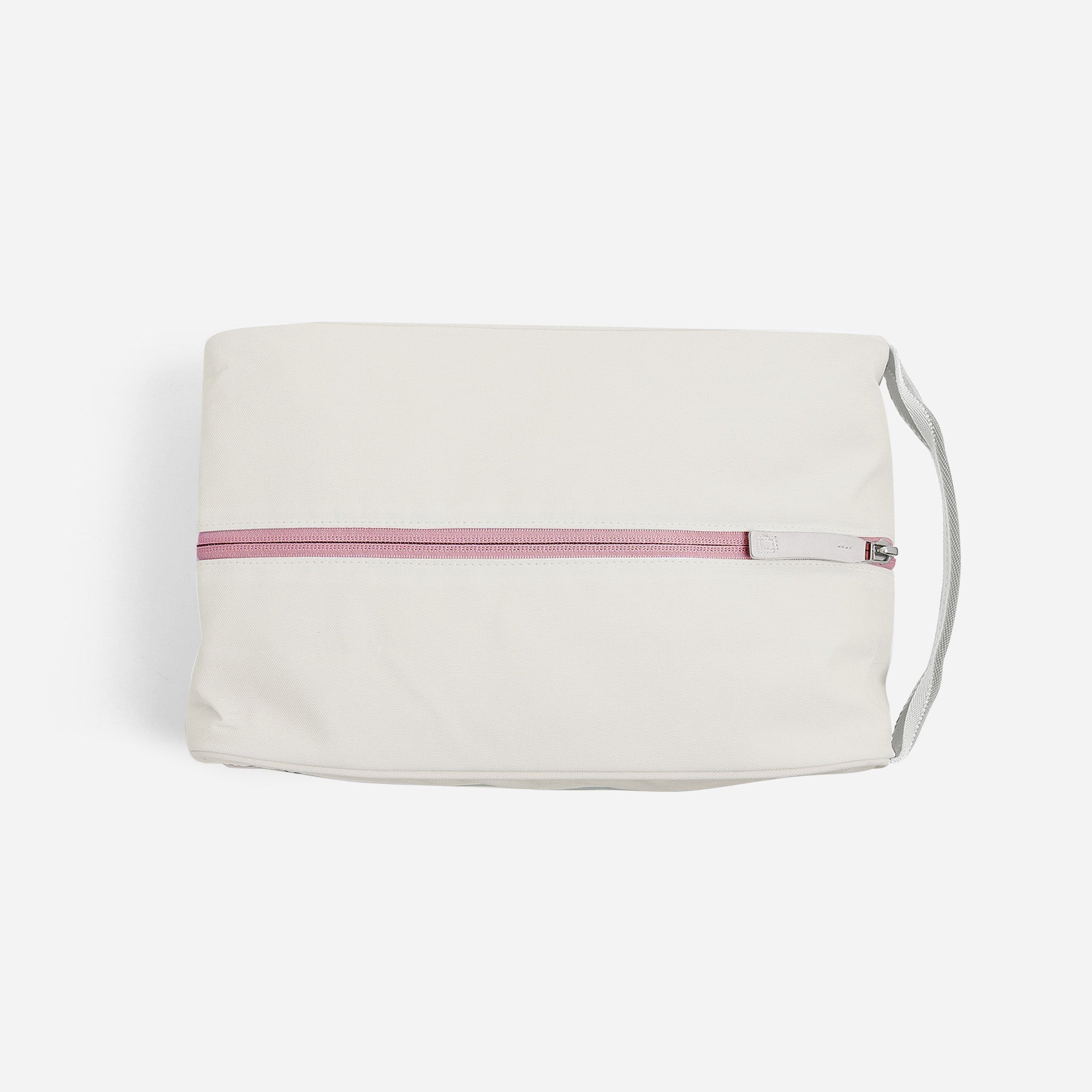 White cosmetic bag with pink zipper and gray handle.