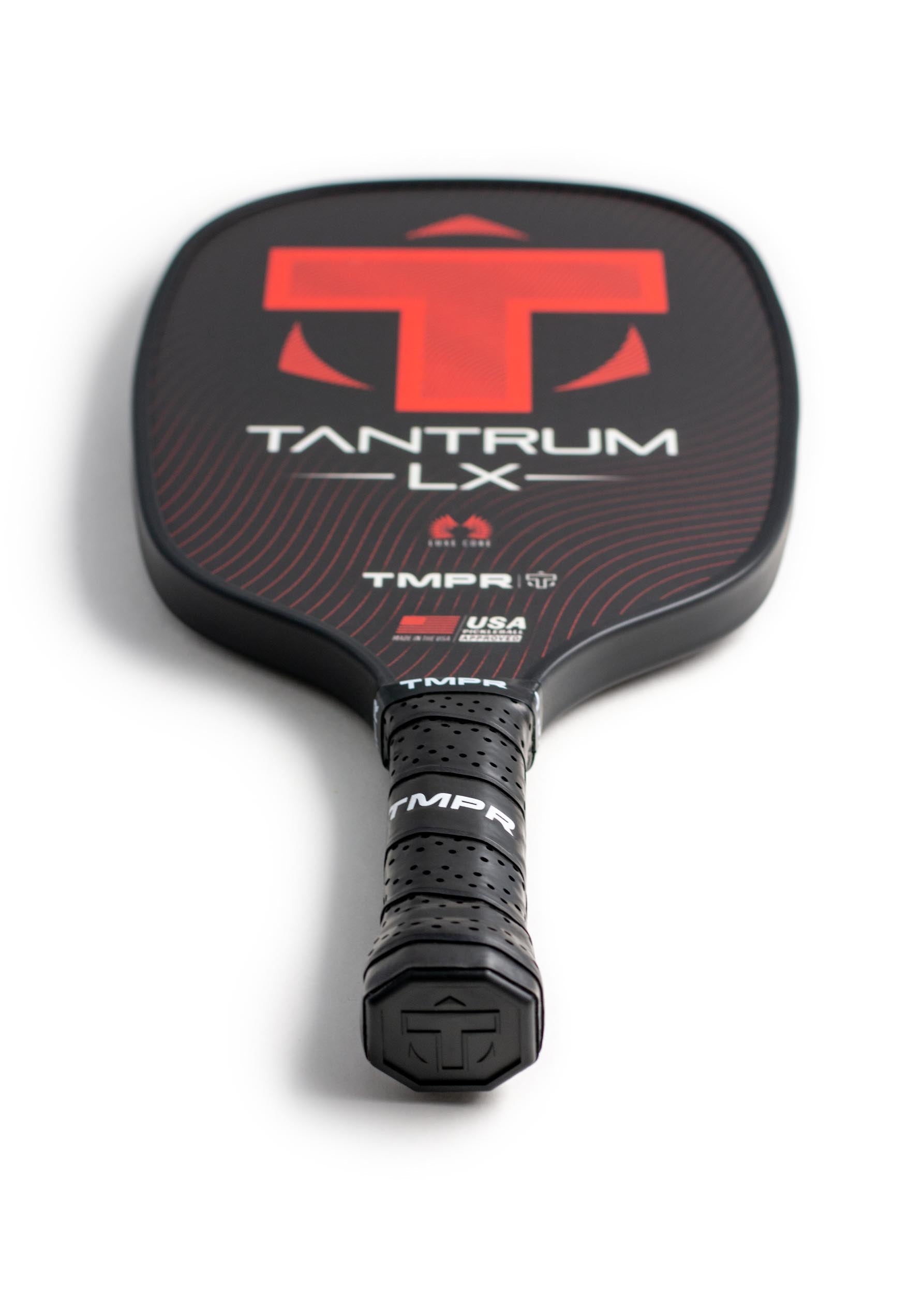 Angled view of a black and red pickleball paddle by TMPR Sports, featuring a perforated grip and Tantrum LX branding.