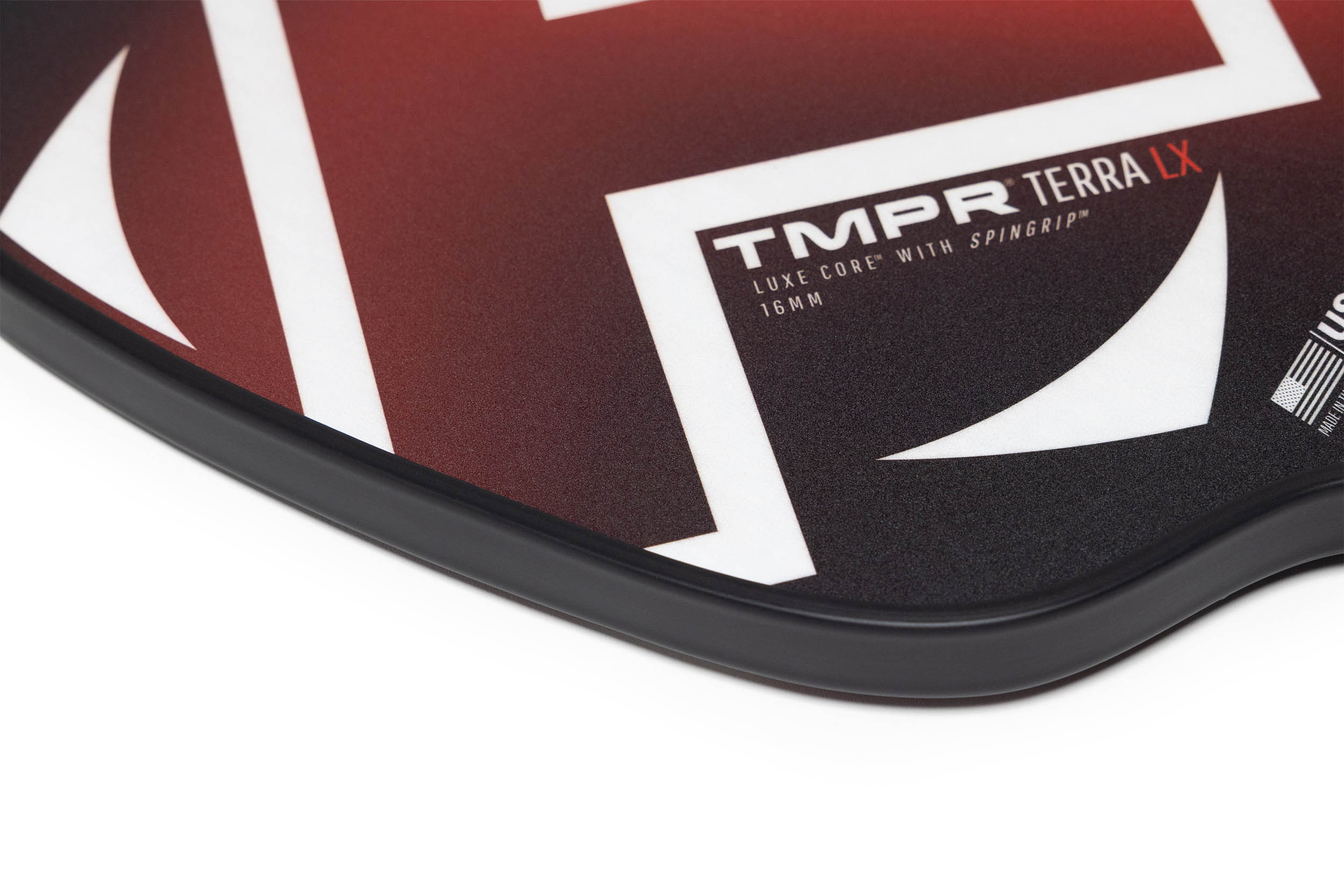 Dark red and black textured pickleball paddle by TMPR Sports, featuring white geometric designs, 'TMPR TERRA' in white, red 'LX', and a black edge guard.