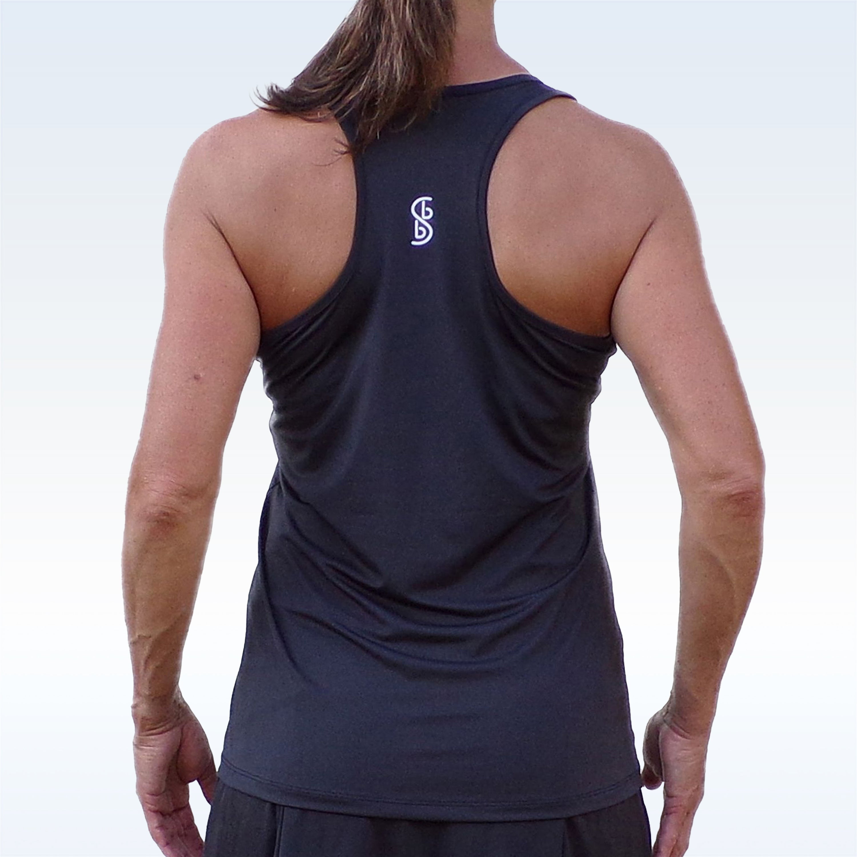 Black racerback tank by Pickleball Bella with a white logo on the back, worn by a person with brown hair.