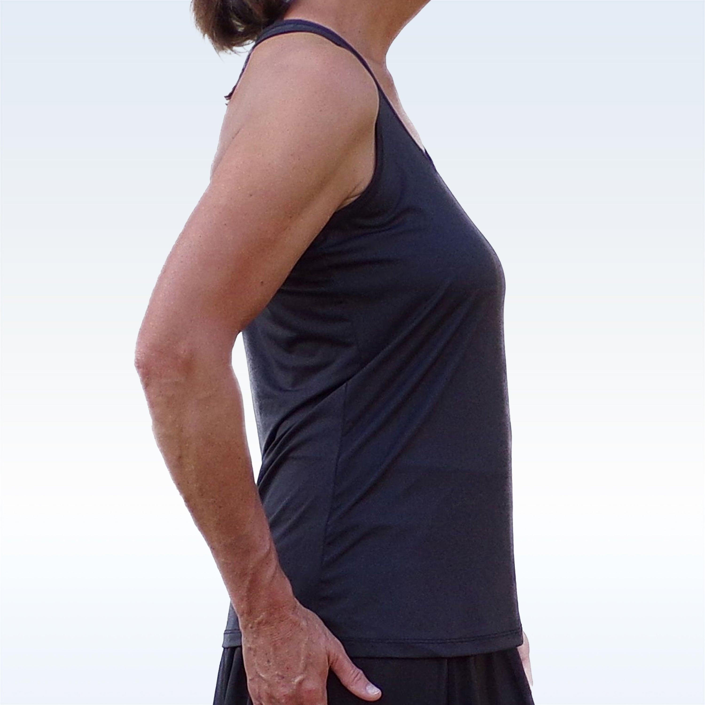 Black Racerback Tank by Pickleball Bella, side view on a woman with thin straps and smooth fabric.