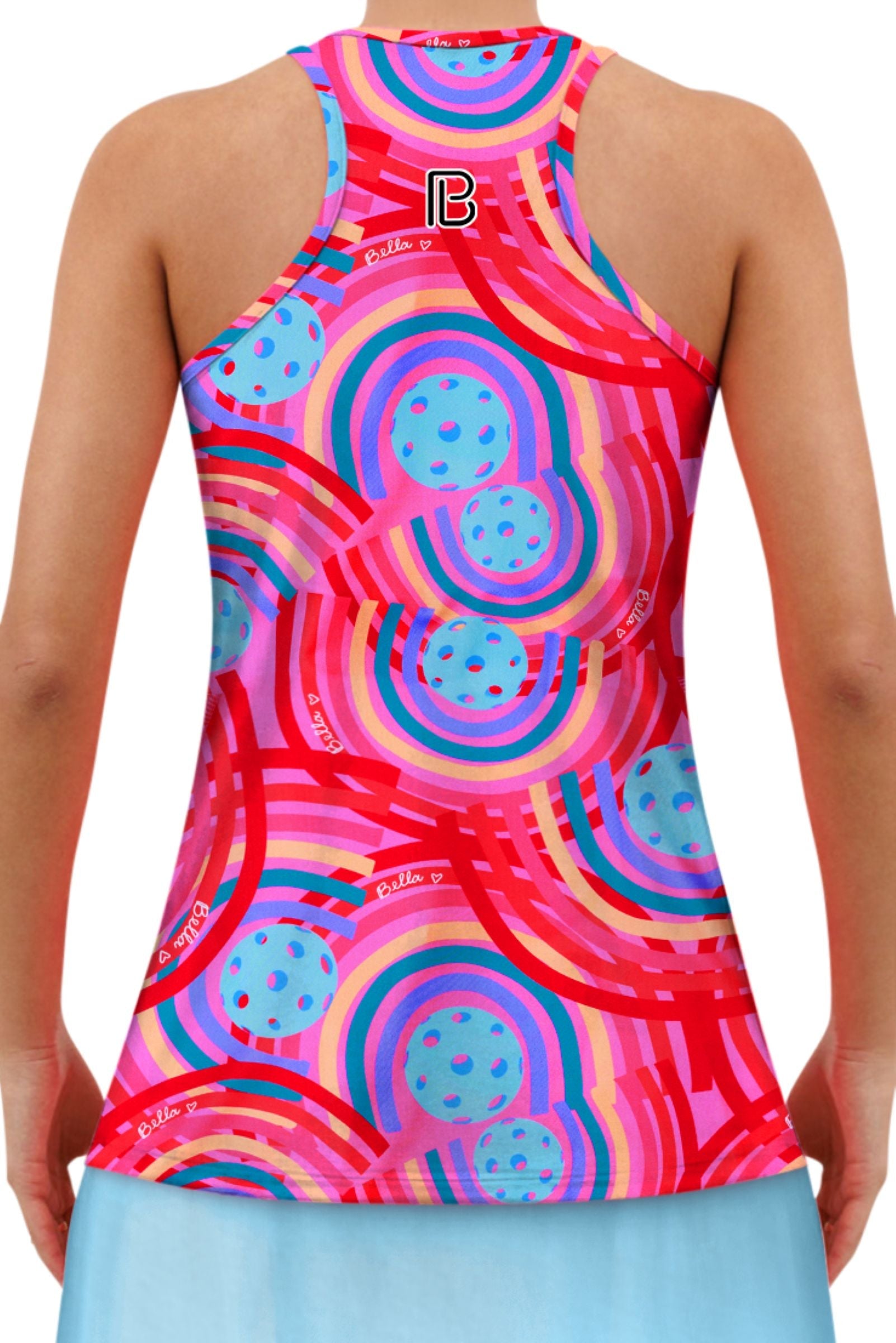 Vibrant pink racerback tank by Pickleball Bella, patterned with colorful rainbows and pickleballs, featuring a prominent 'B' logo, worn from the back over a light blue skirt.
