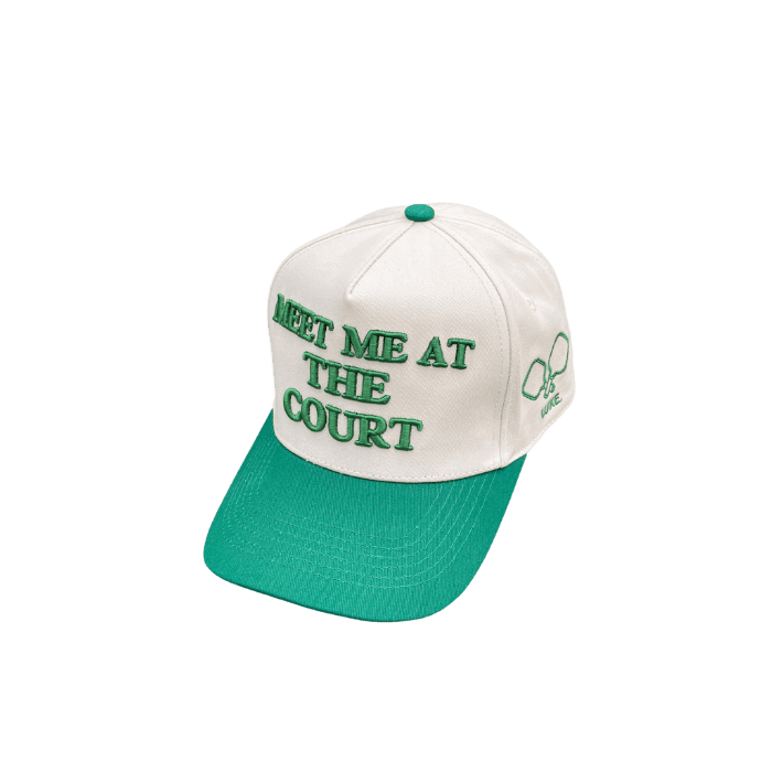 White and green baseball cap with embroidered text and graphic.