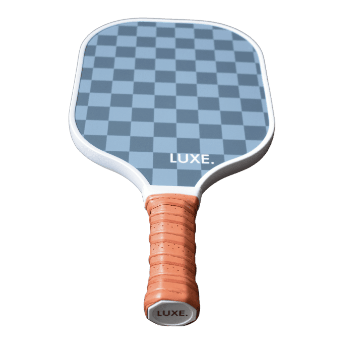 Pickleball paddle with blue checkered pattern and orange grip.