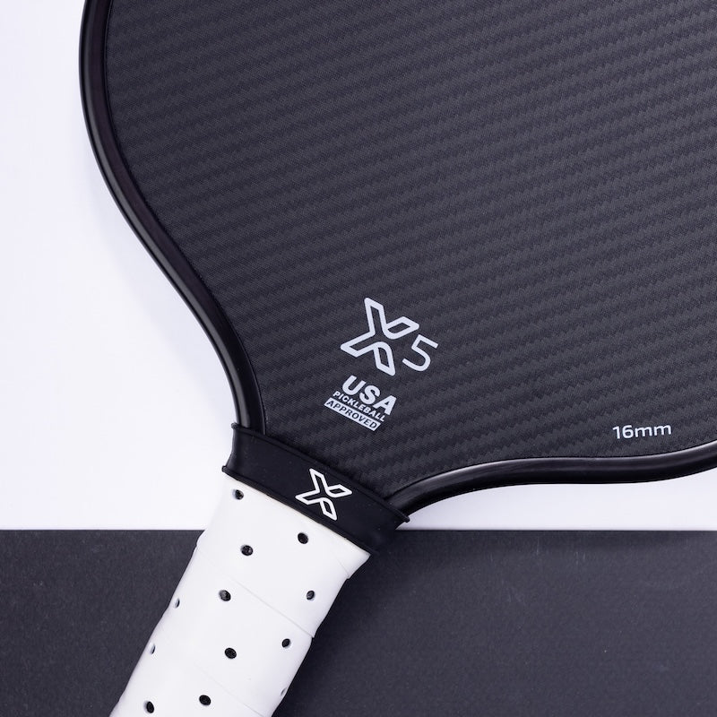 Black and white pickleball paddle with white grip.