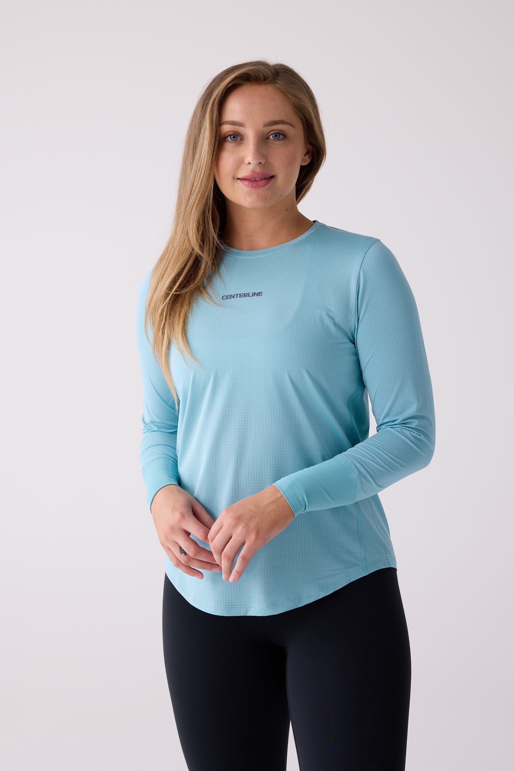 Light blue perforated long sleeve shirt by Centerline Athletics, with visible logo and black leggings.