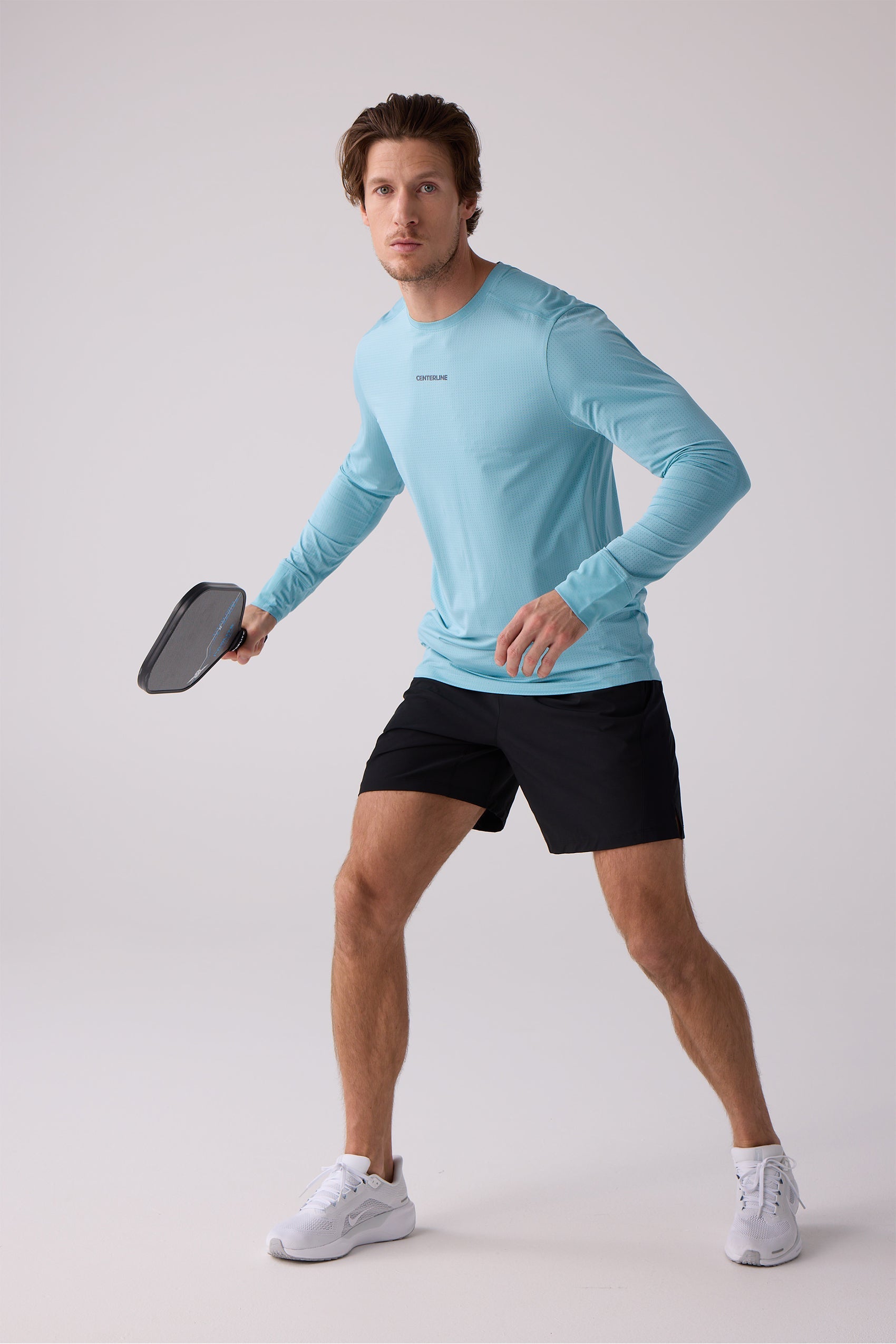 Light blue AirLite long sleeve shirt by Centerline Athletics featuring 'CENTERLINE' text and a perforated texture, worn by a man.