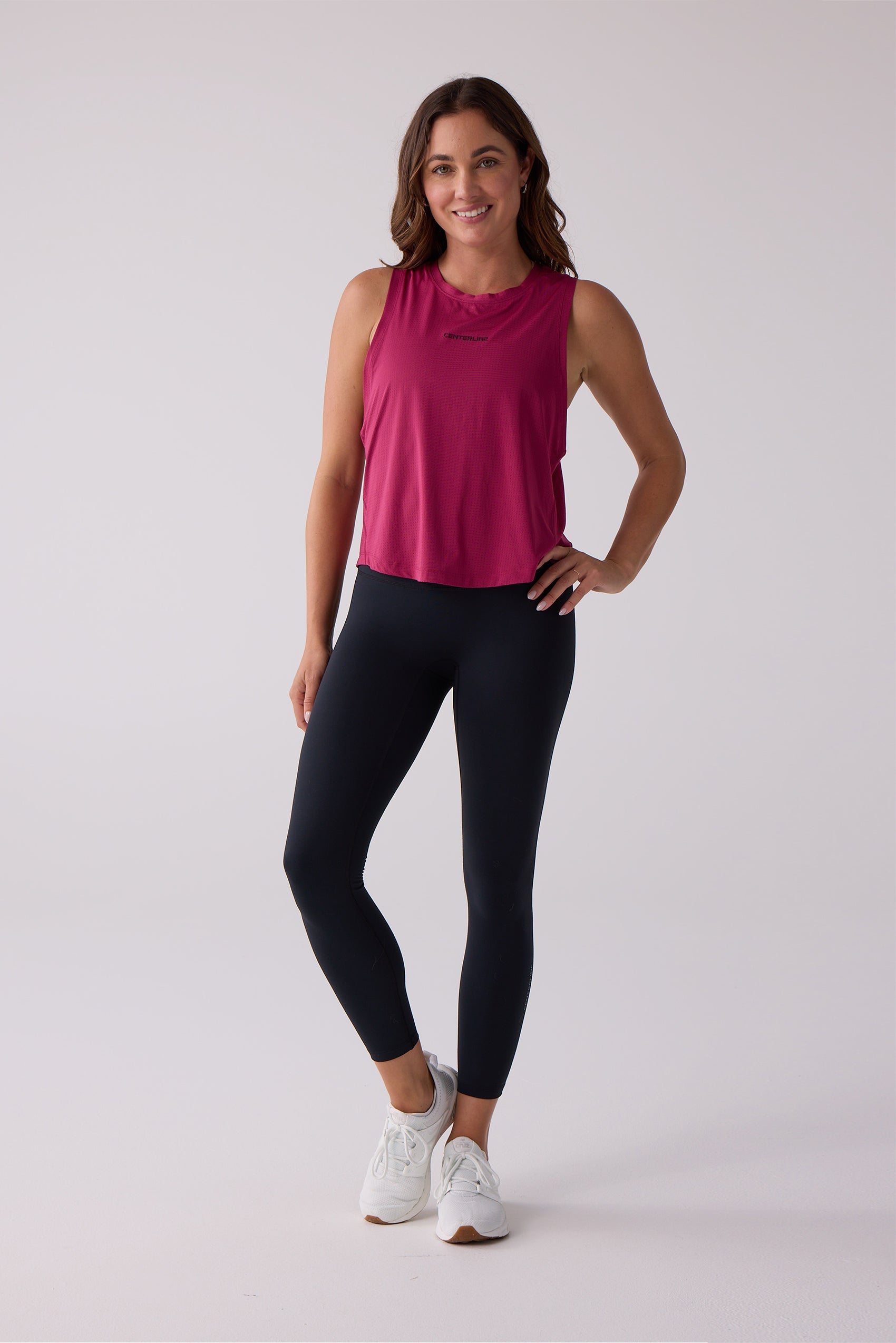 Magenta AirLite tank by Centerline Athletics, with 'CENTERLINE' text on breathable fabric, styled with black leggings.