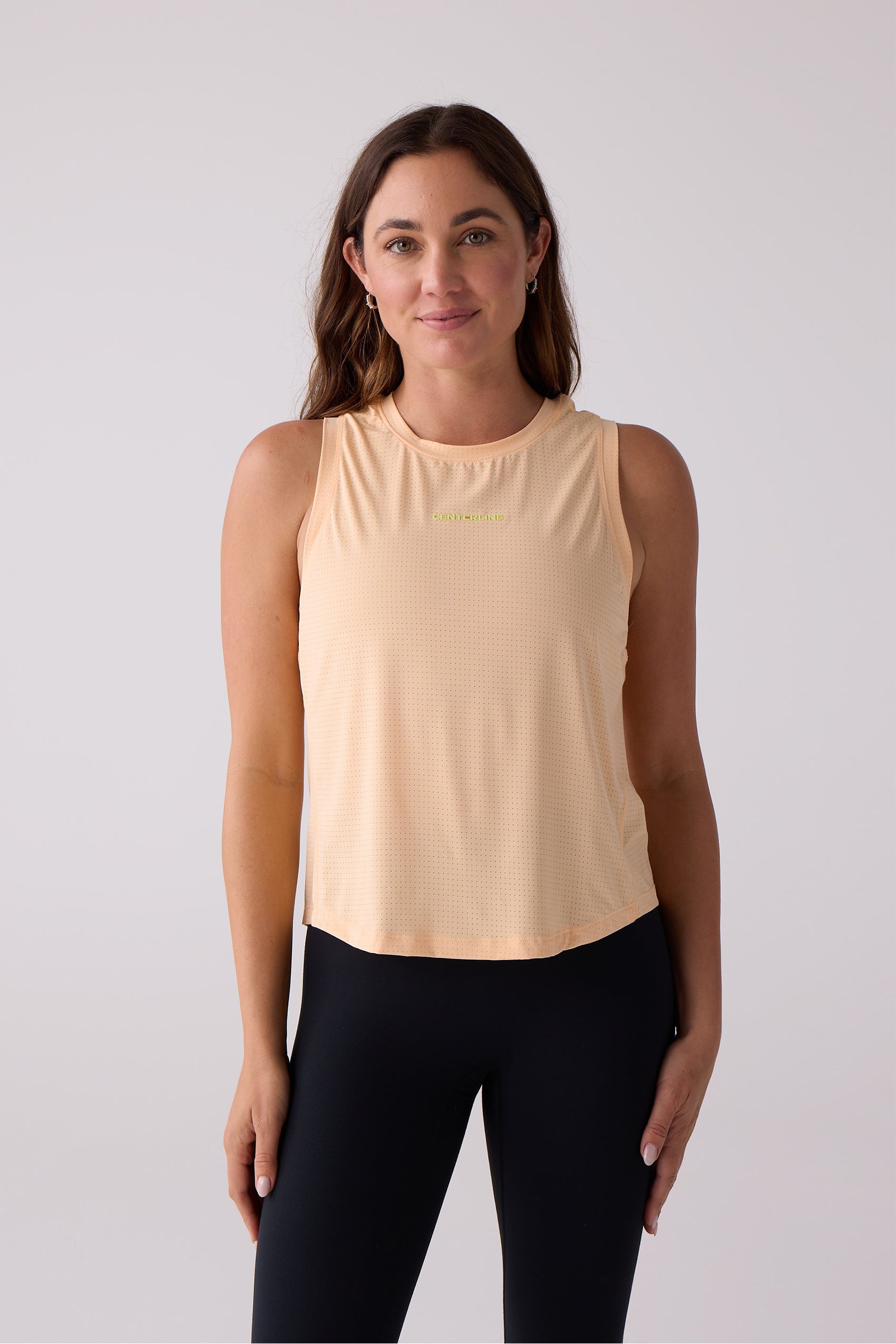 Peach perforated women's AirLite tank by Centerline Athletics, featuring a lime green 'CENTERLINE' logo.