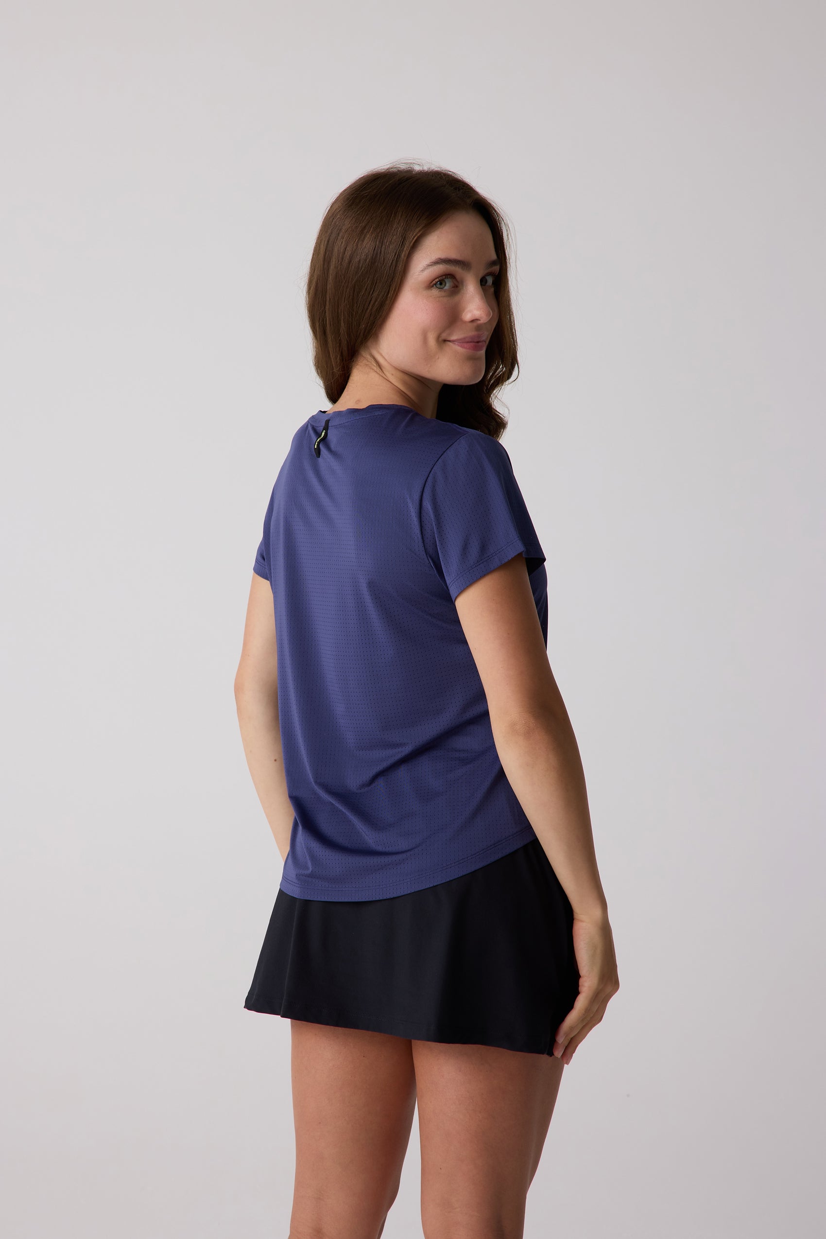 Women's dark blue AirLite Tee by Centerline Athletics, featuring perforated mesh fabric, shown from a rear angle.