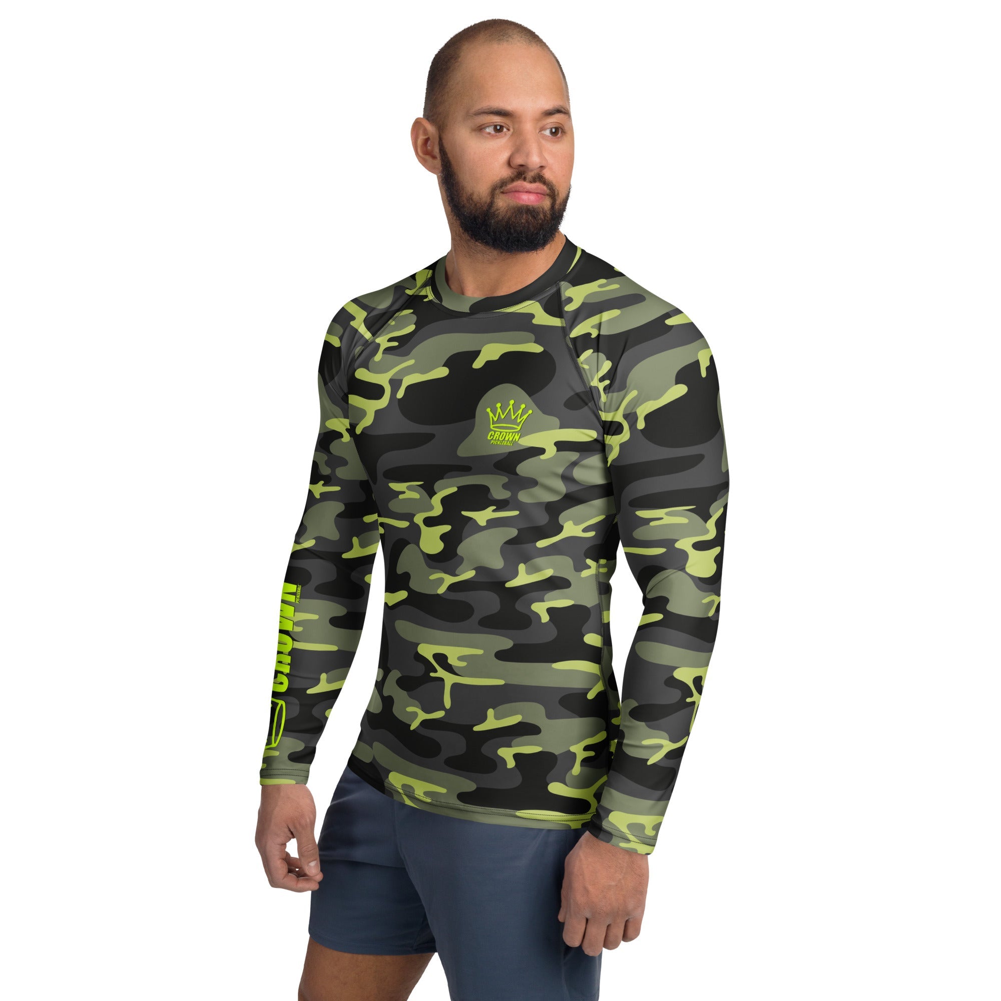 Man in camouflage long-sleeve rash guard and blue shorts.