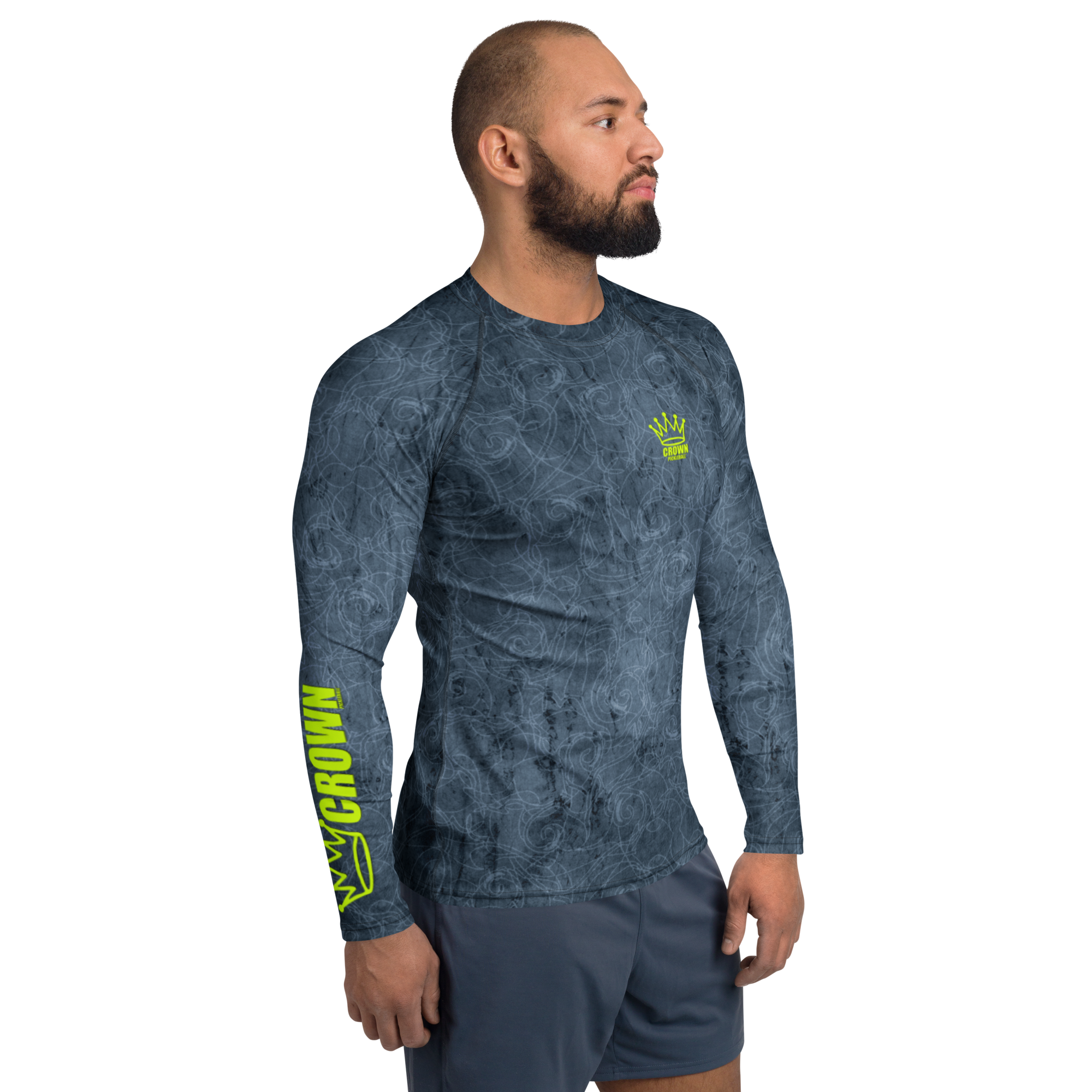 Man wearing a gray patterned long-sleeve shirt and shorts, looking to the right.