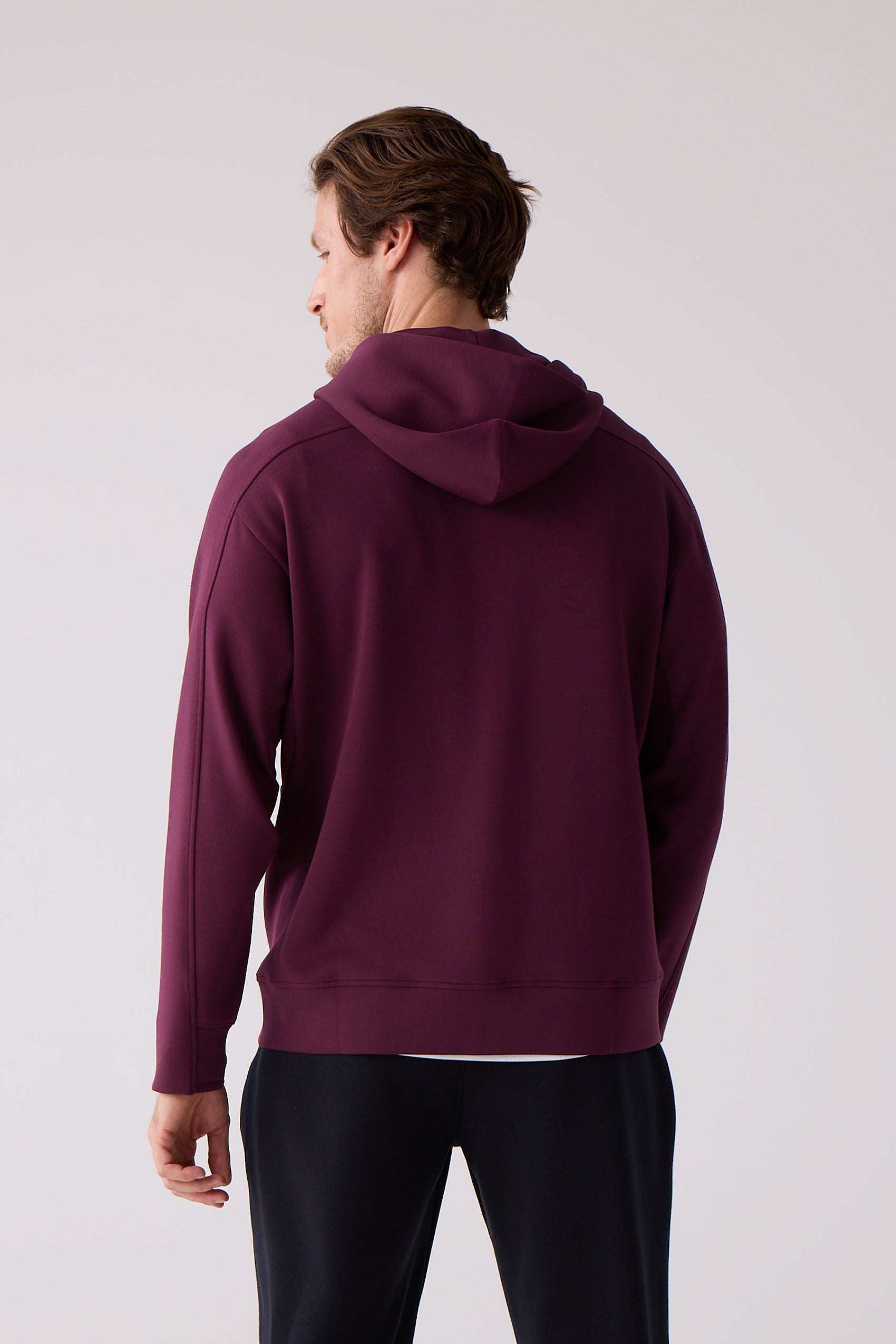 Deep plum hoodie by Centerline Athletics, back view, with distinct raglan seams and ribbed cuffs.
