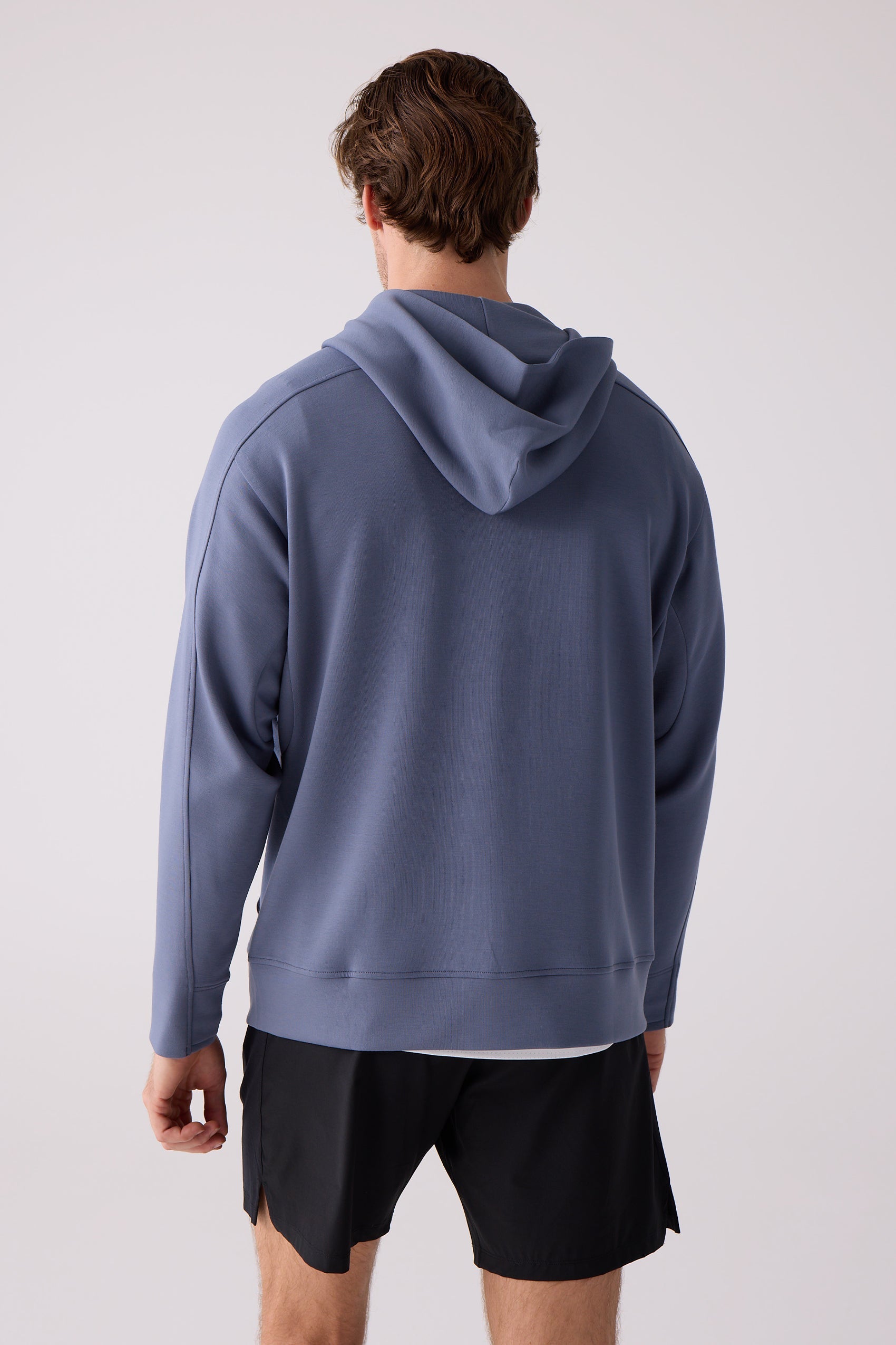 Slate blue sweatshirt by Centerline Athletics, featuring a hood, shown from the back on a man wearing black shorts.