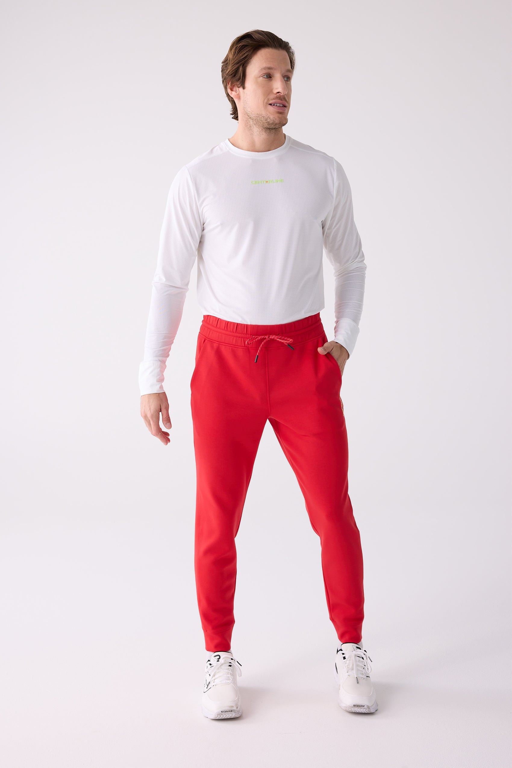 Red men's Après Jogger by Centerline Athletics with a red drawstring, styled with a white long-sleeve shirt and white sneakers.