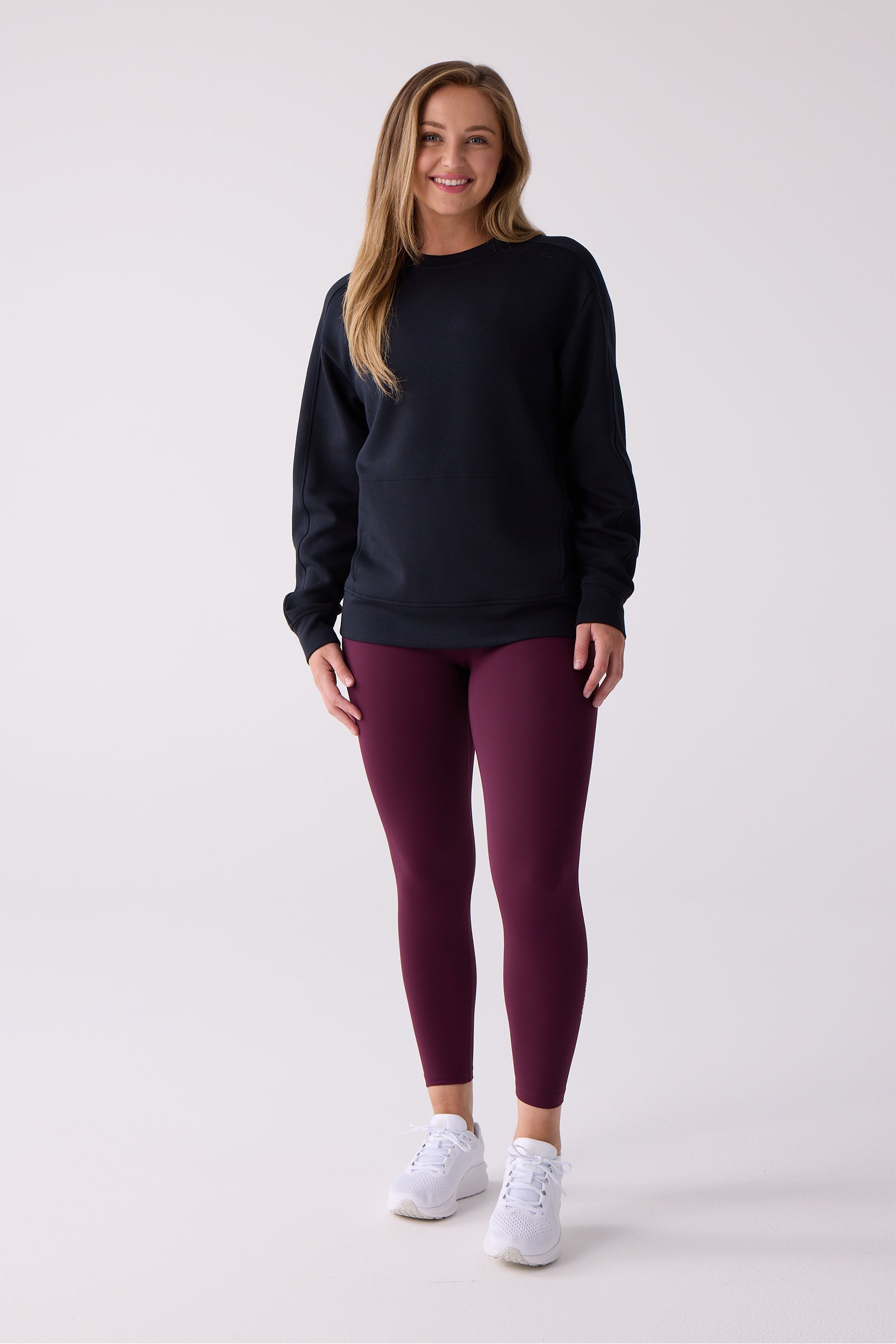 Black Women's Crew Sweatshirt by Centerline Athletics, styled with maroon leggings and white sneakers.