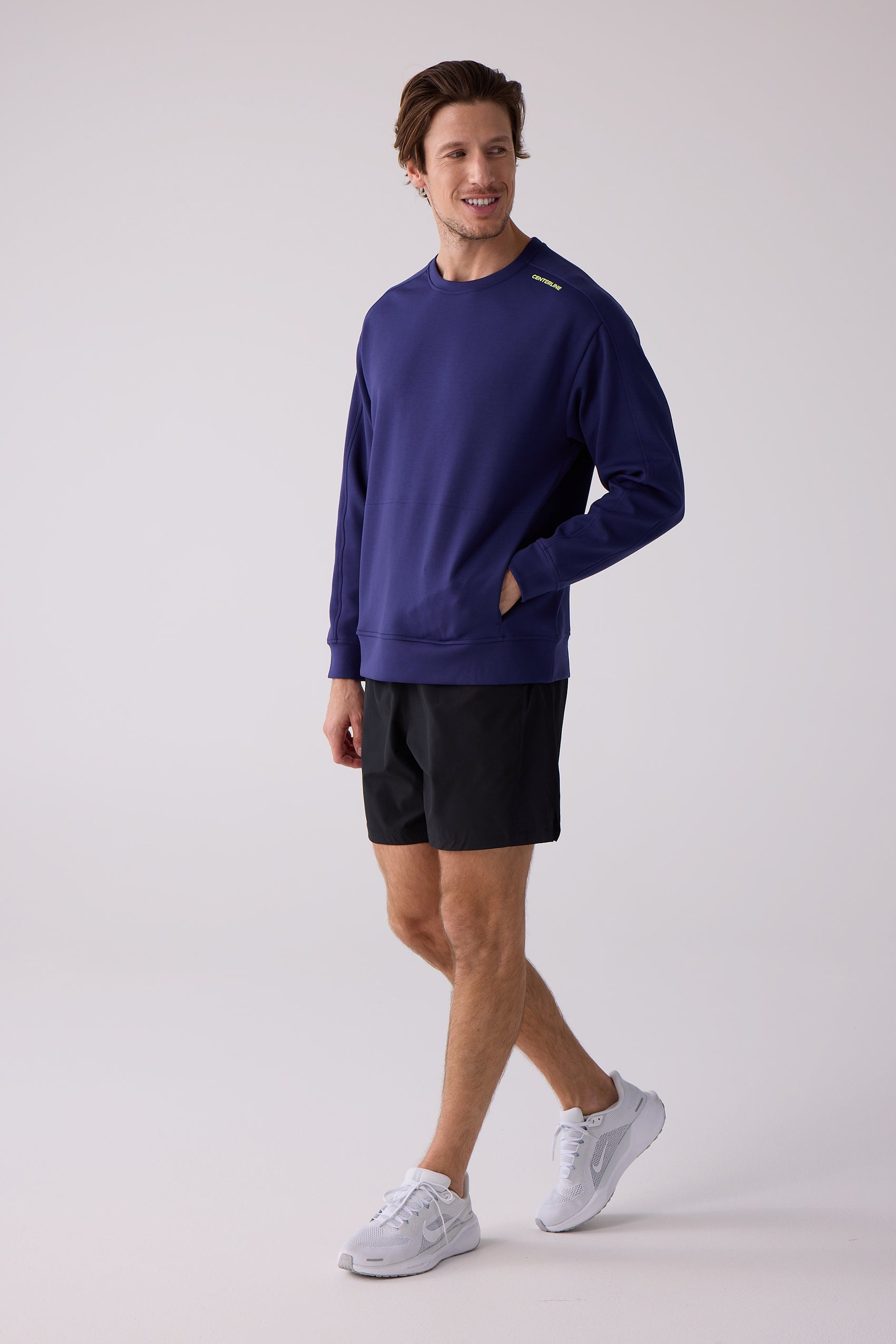 Deep purple men's crew sweatshirt by Centerline Athletics with yellow 'CENTERLINE' text on the shoulder and hand in pocket.