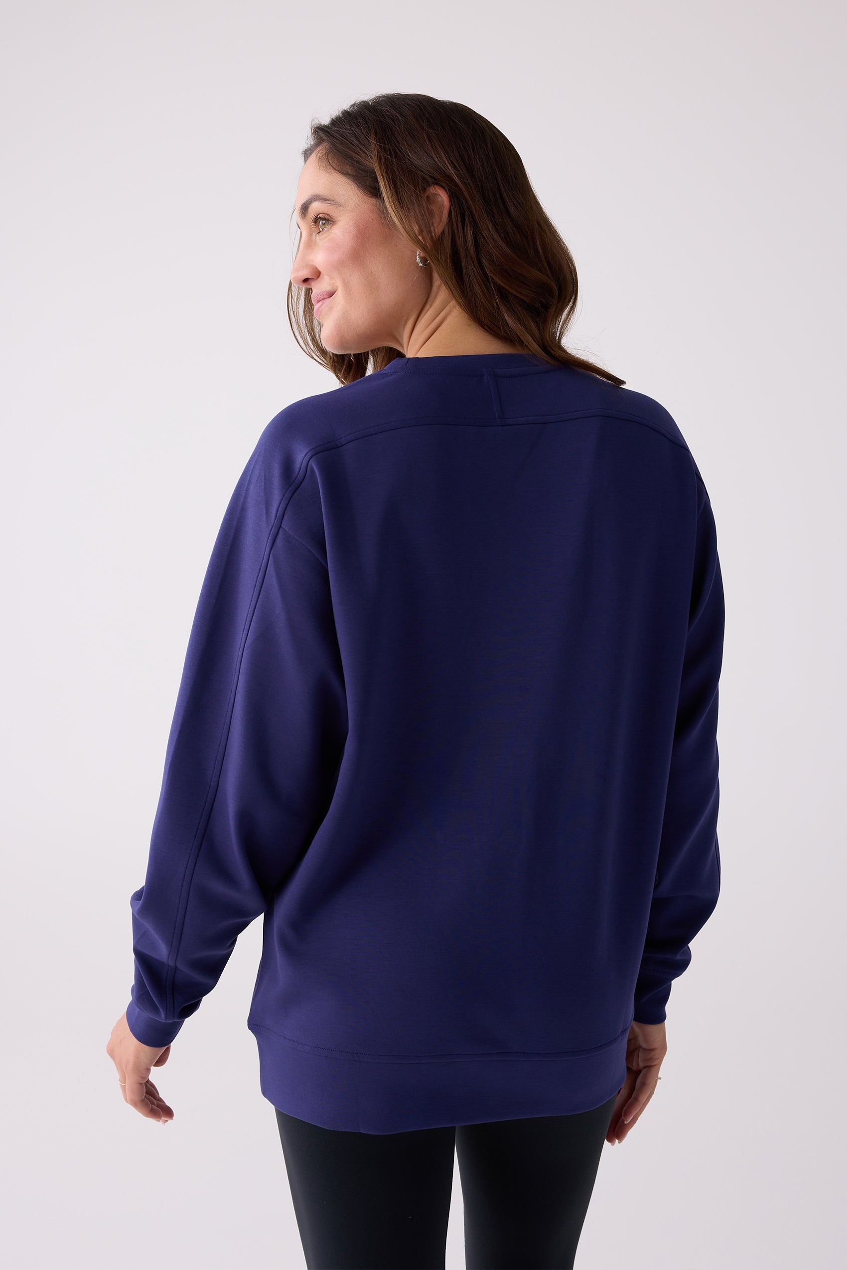 Navy crew sweatshirt by Centerline Athletics with visible stitching on the shoulders and back yoke, worn by a woman from behind.