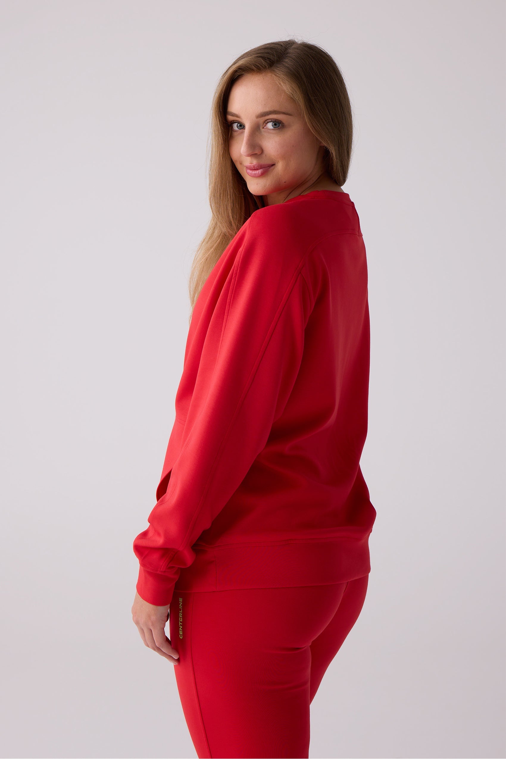 Red Après Women's Crew Sweatshirt by Centerline Athletics, featuring a relaxed fit, styled with matching red pants.