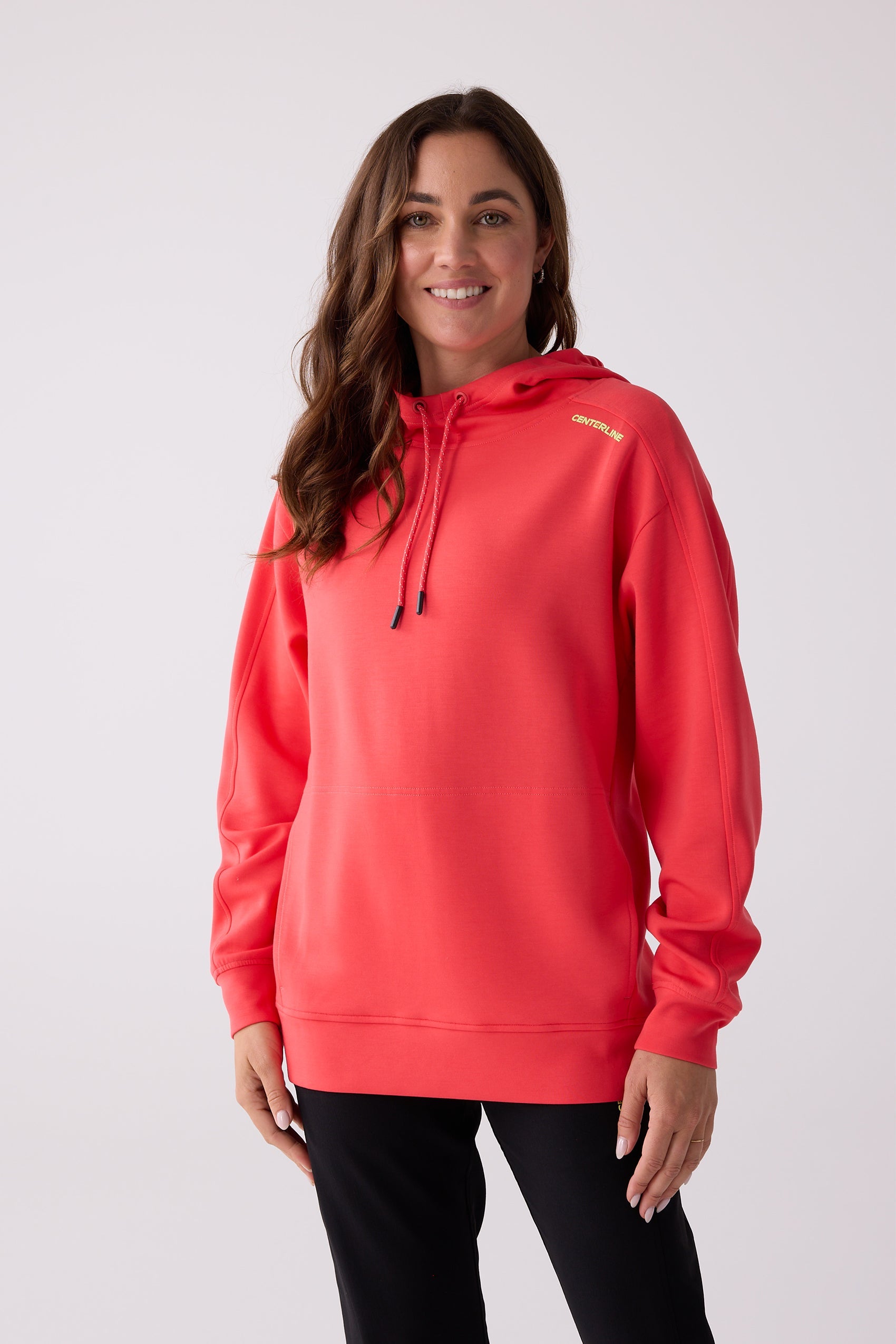 Coral women's hooded sweatshirt by Centerline Athletics, featuring a drawstring hood and yellow brand text on the shoulder.