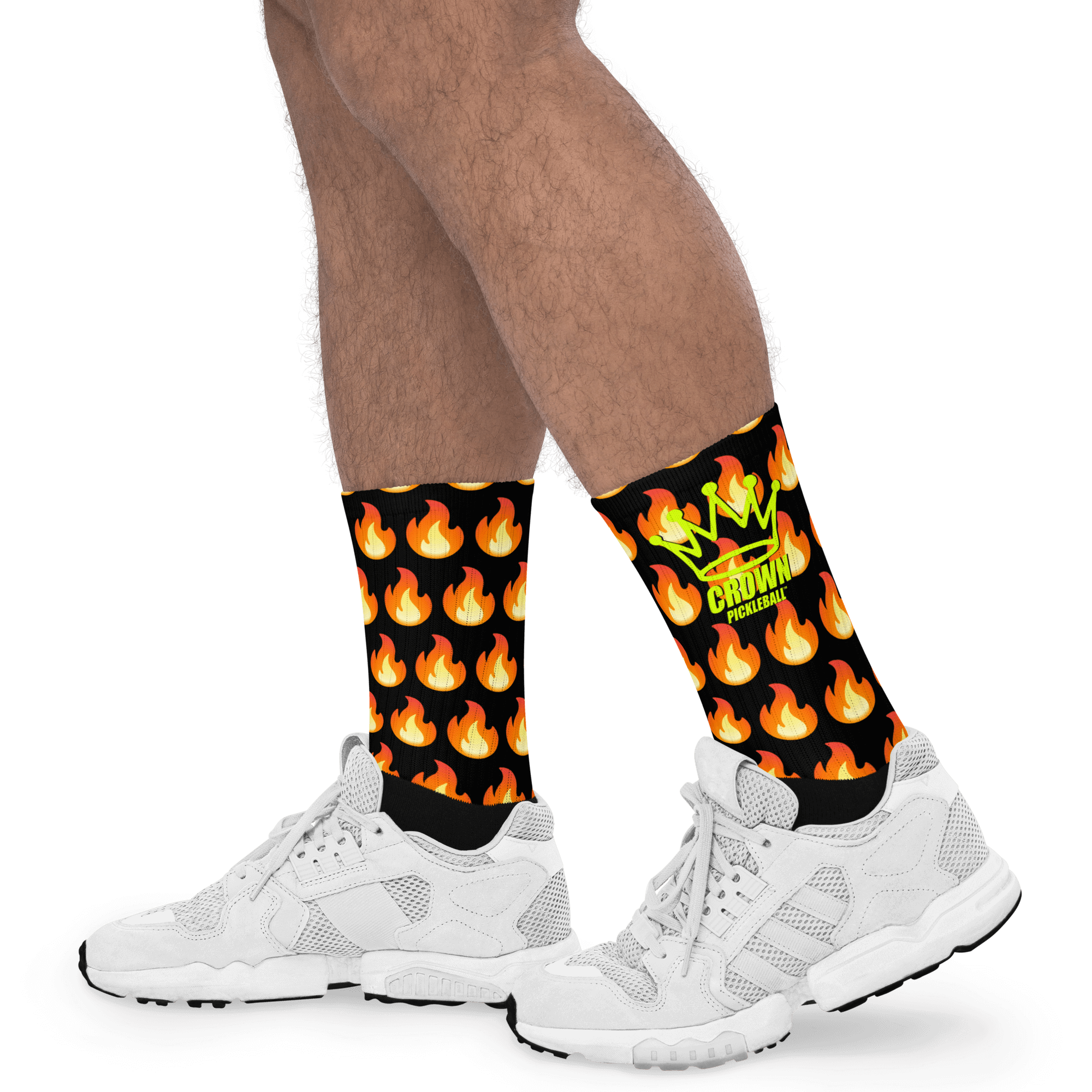 Human legs wearing black socks with a flame pattern and white running shoes.