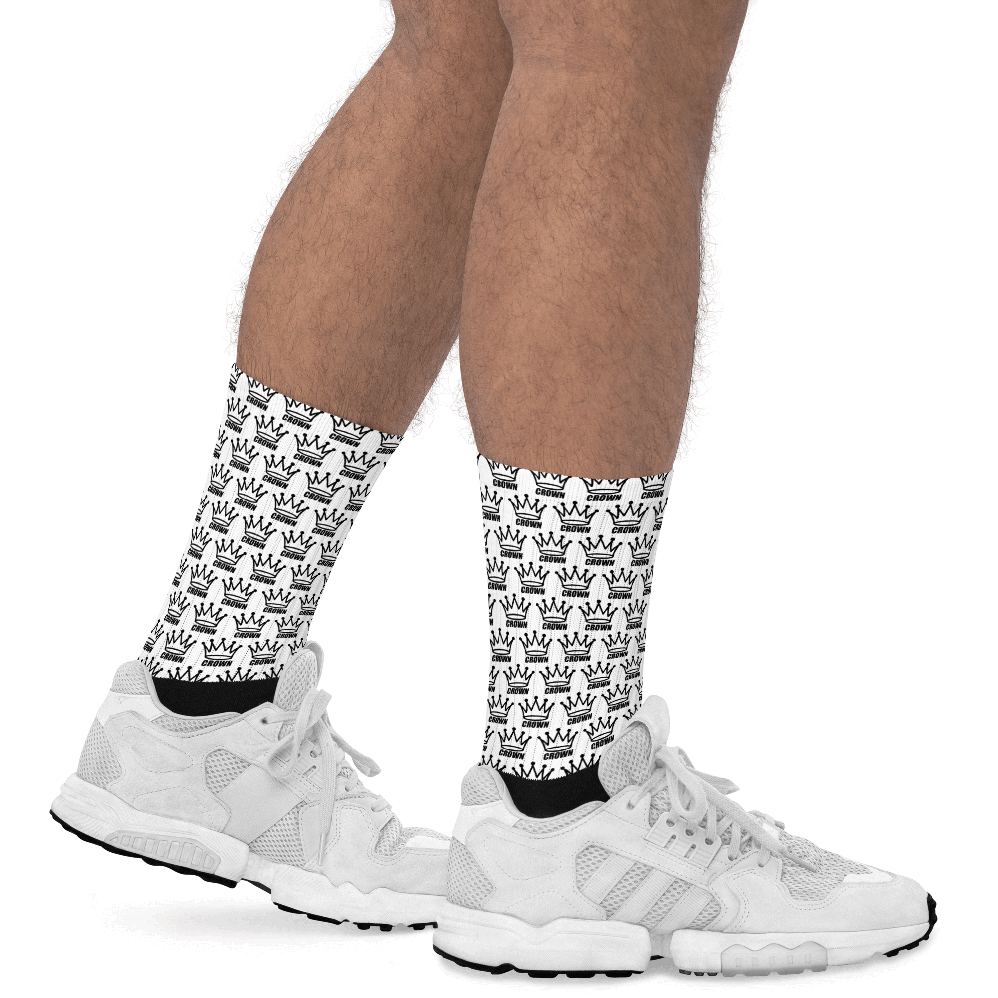 Legs wearing patterned socks and white sneakers.