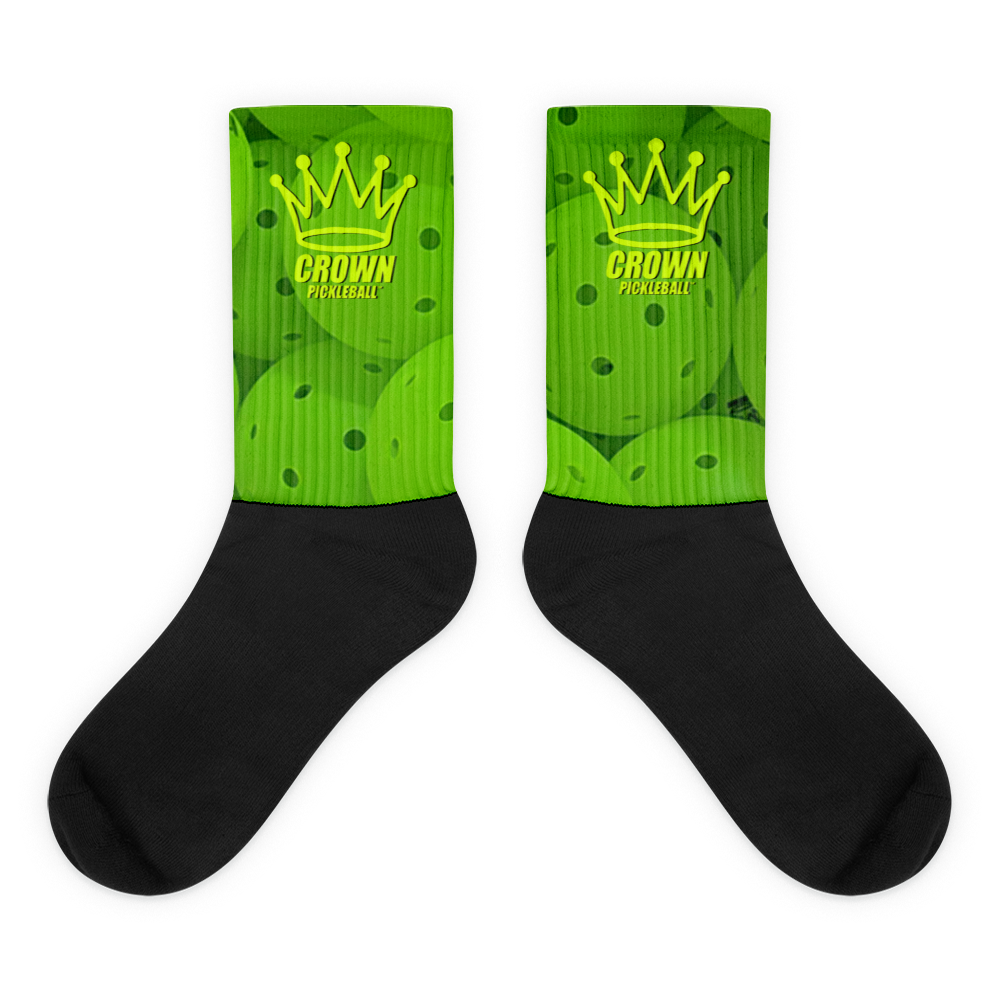 Two black-and-green pickleball socks.