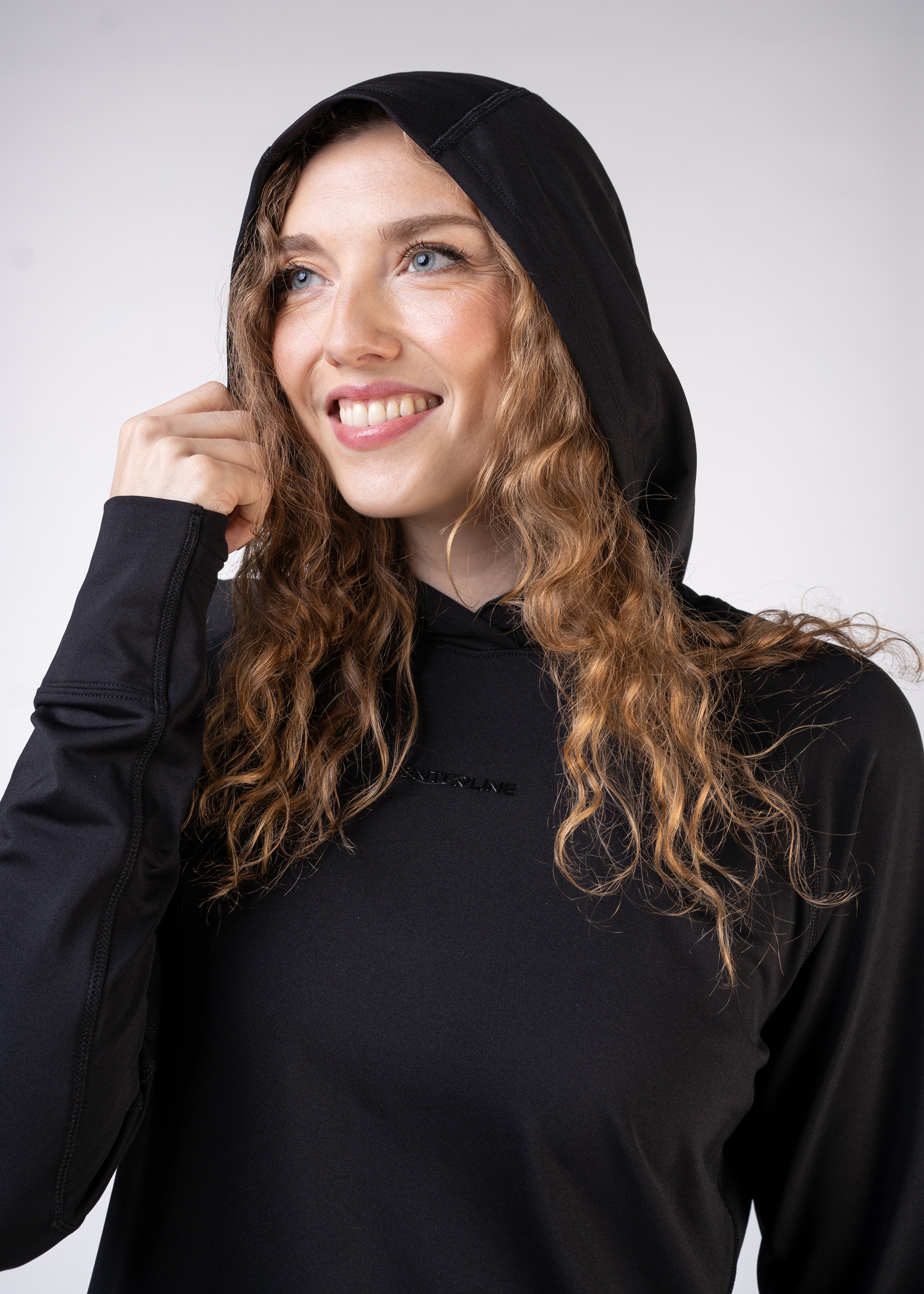A smiling woman wearing a black hoodie.