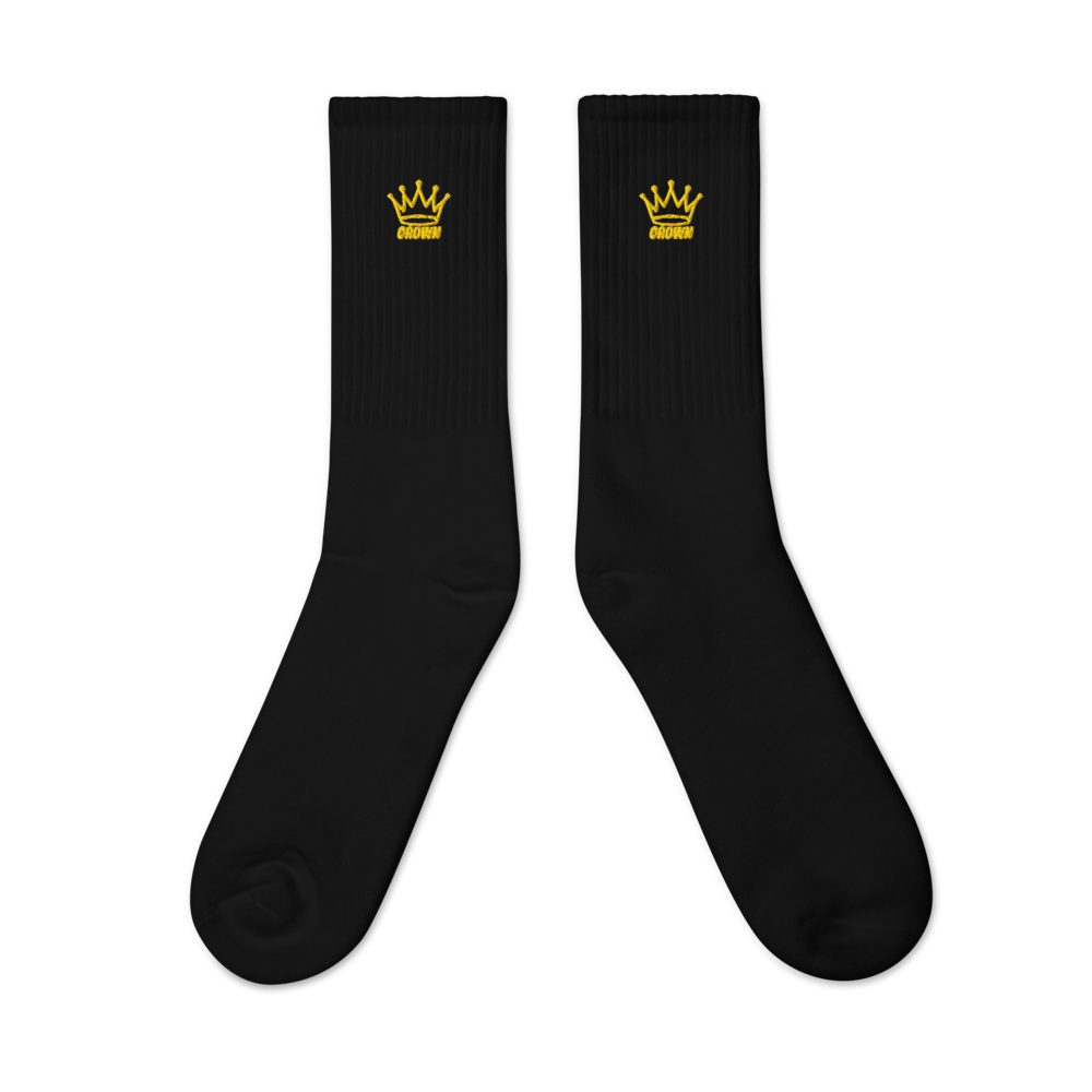 Two black socks with yellow crown logos.