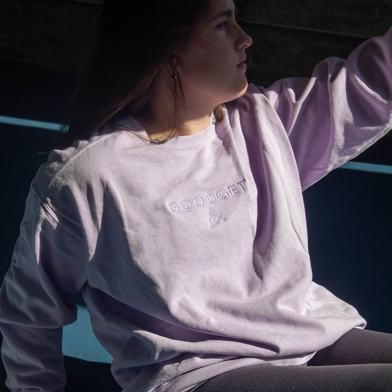 Light purple tone-on-tone embroidered sweatshirt by Good Get, worn by a woman, featuring a crew neck and long sleeves.