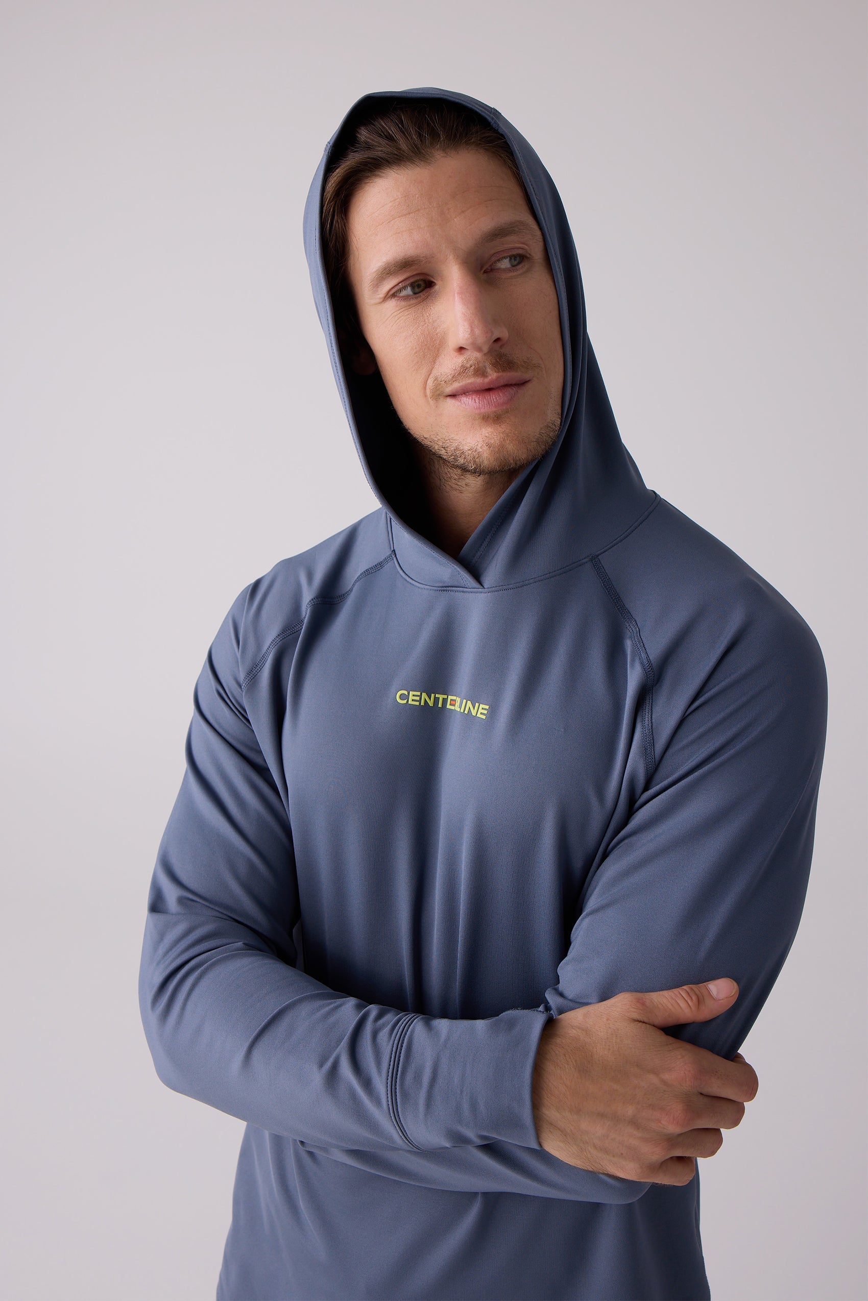 Blue men's layering hoodie by Centerline Athletics, featuring a neon yellow chest logo and raglan sleeves.