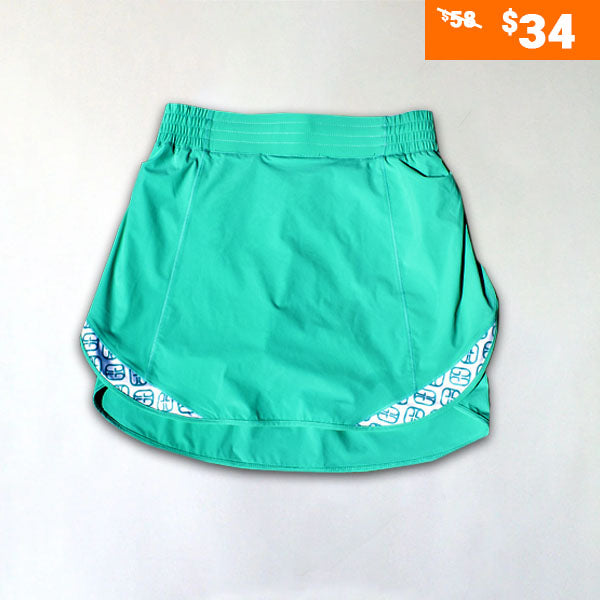 Teal performance pickleball skirt by Good Get, with a white patterned liner and elastic waistband, presented as a flat lay.