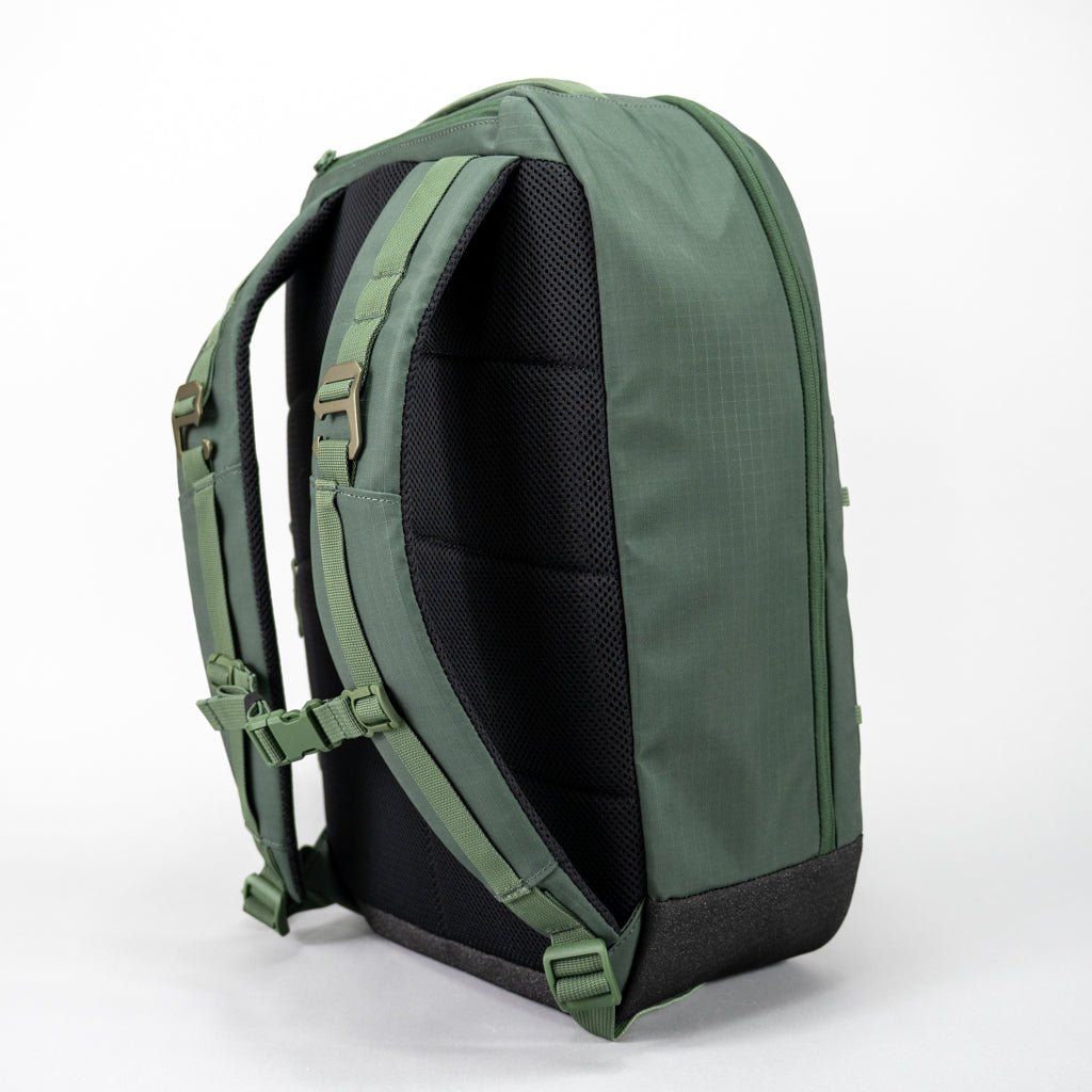 Green ripstop Pickleball Backpack by FORWRD with padded mesh back panel, adjustable shoulder straps, and chest buckle, shown from the back.